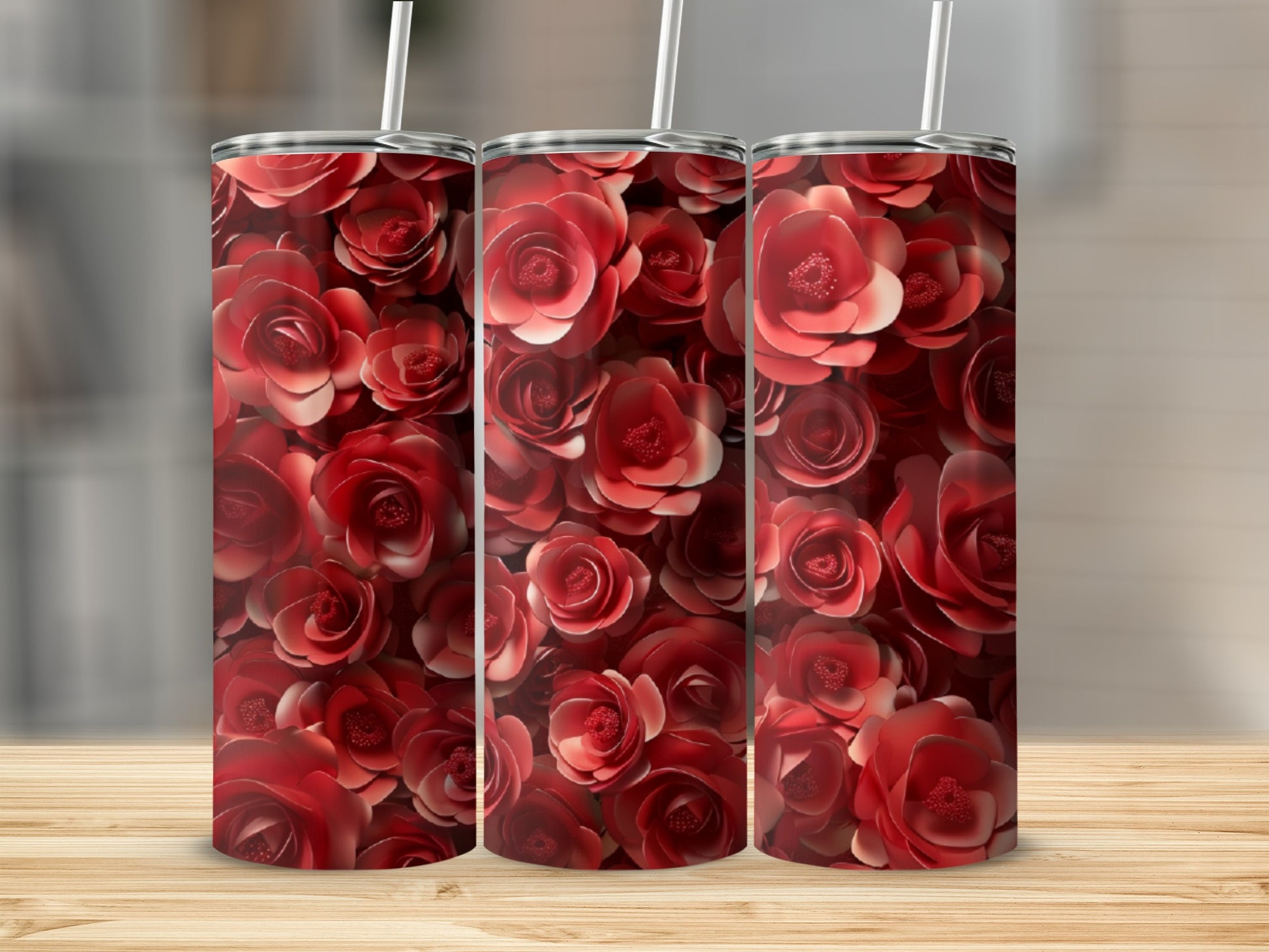 Three tumblers covered in a repeating pattern of red roses.