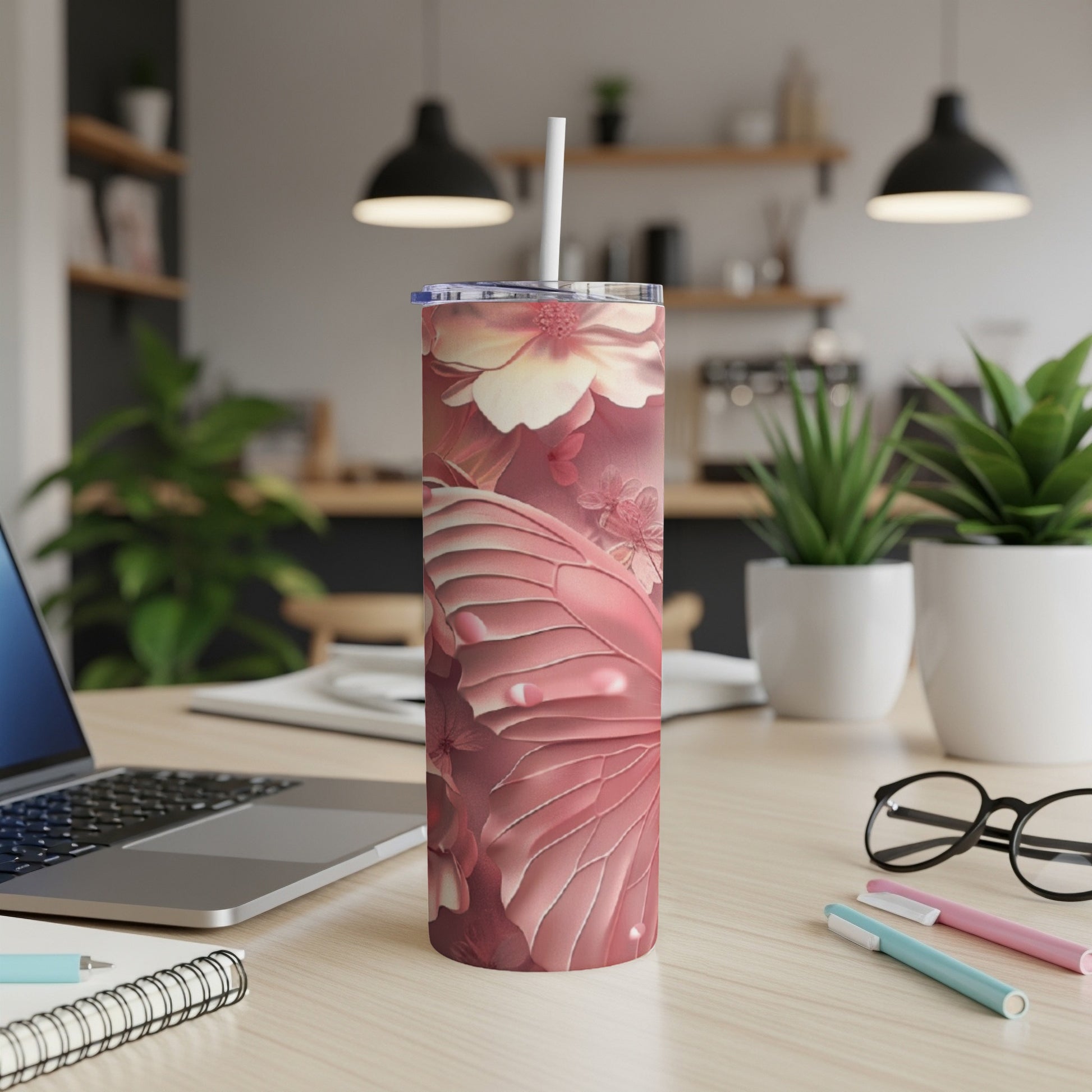 Pink butterfly wing pattern on a tumbler with a straw.