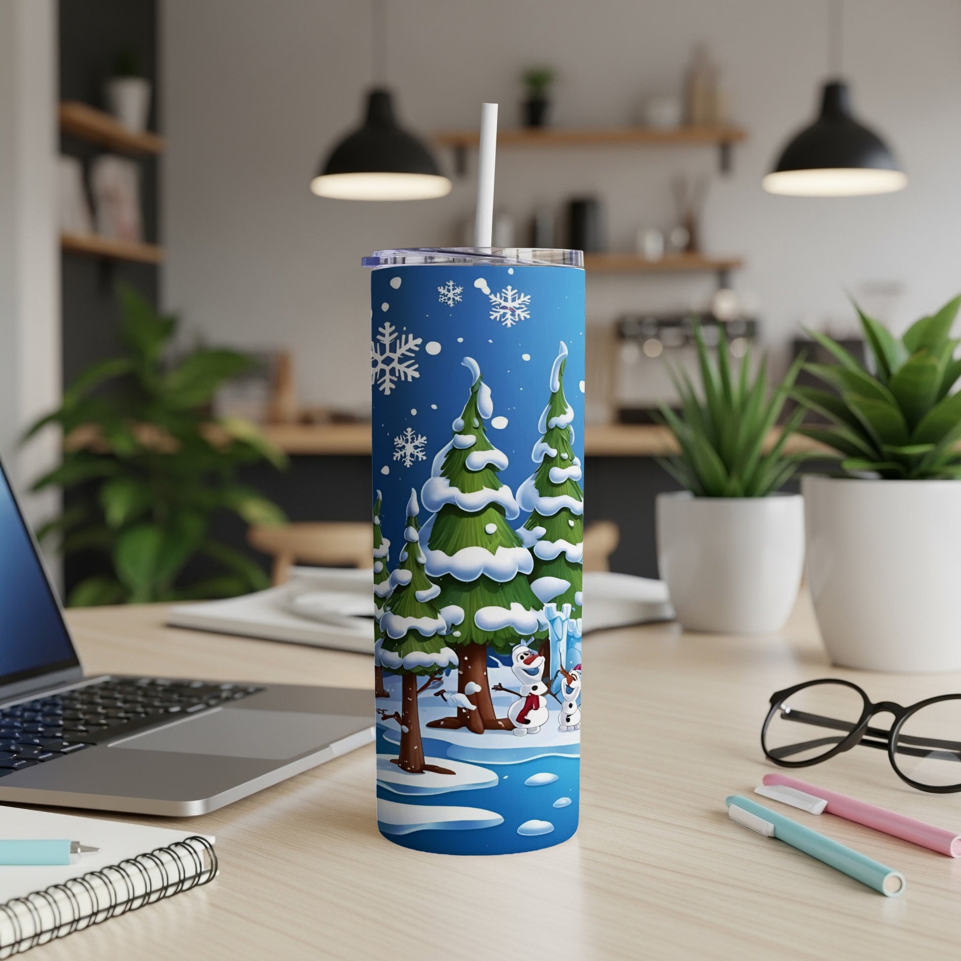 Blue tumbler with snowmen and evergreen trees, lid and straw.