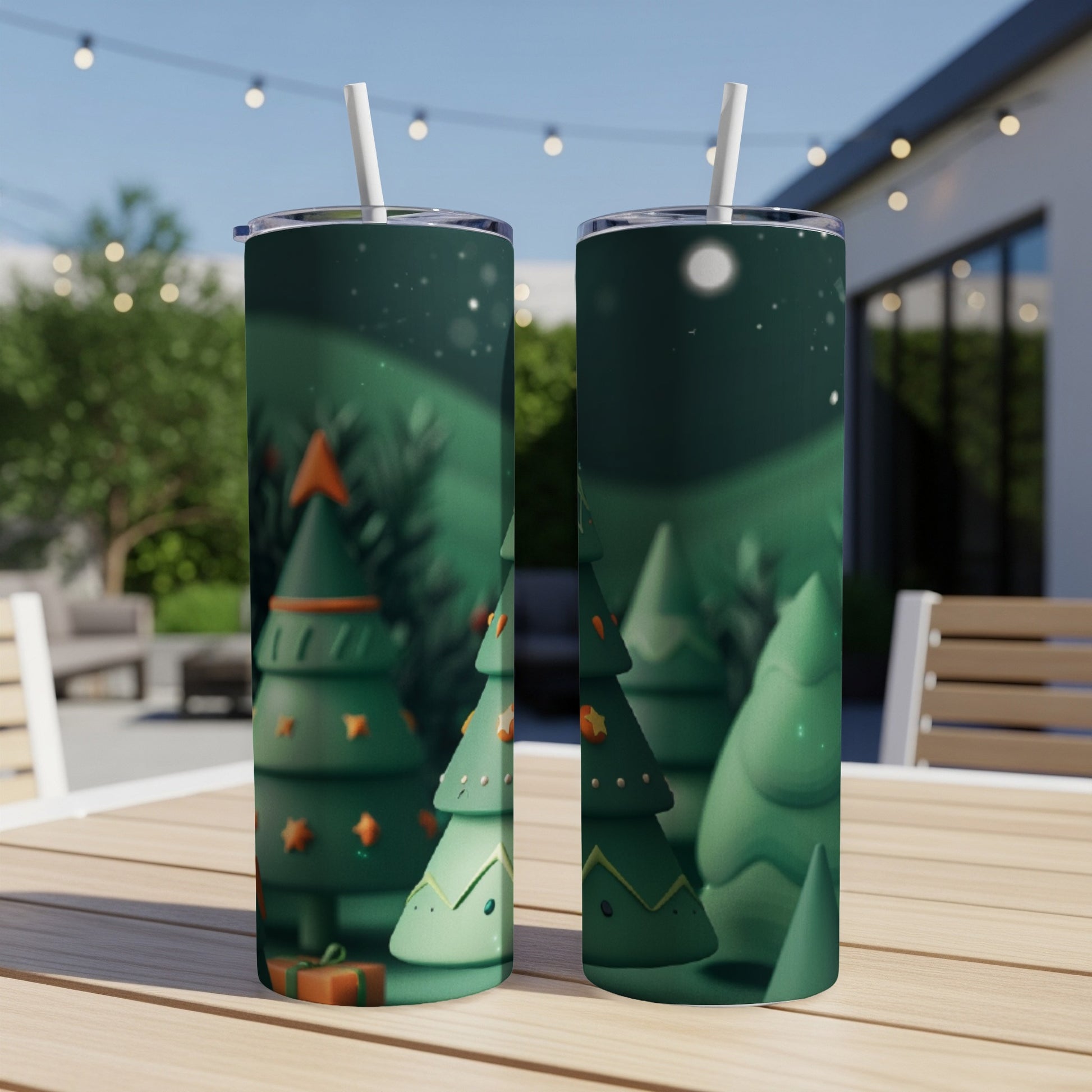 Two tumblers with a green Christmas forest scene and twinkling stars.