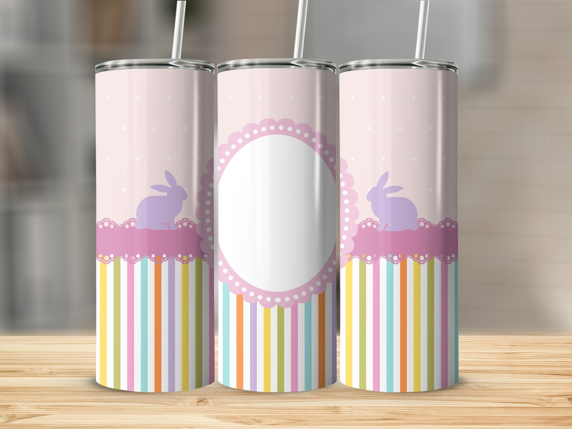 Pink tumbler with bunnies and striped pattern, customizable oval label.