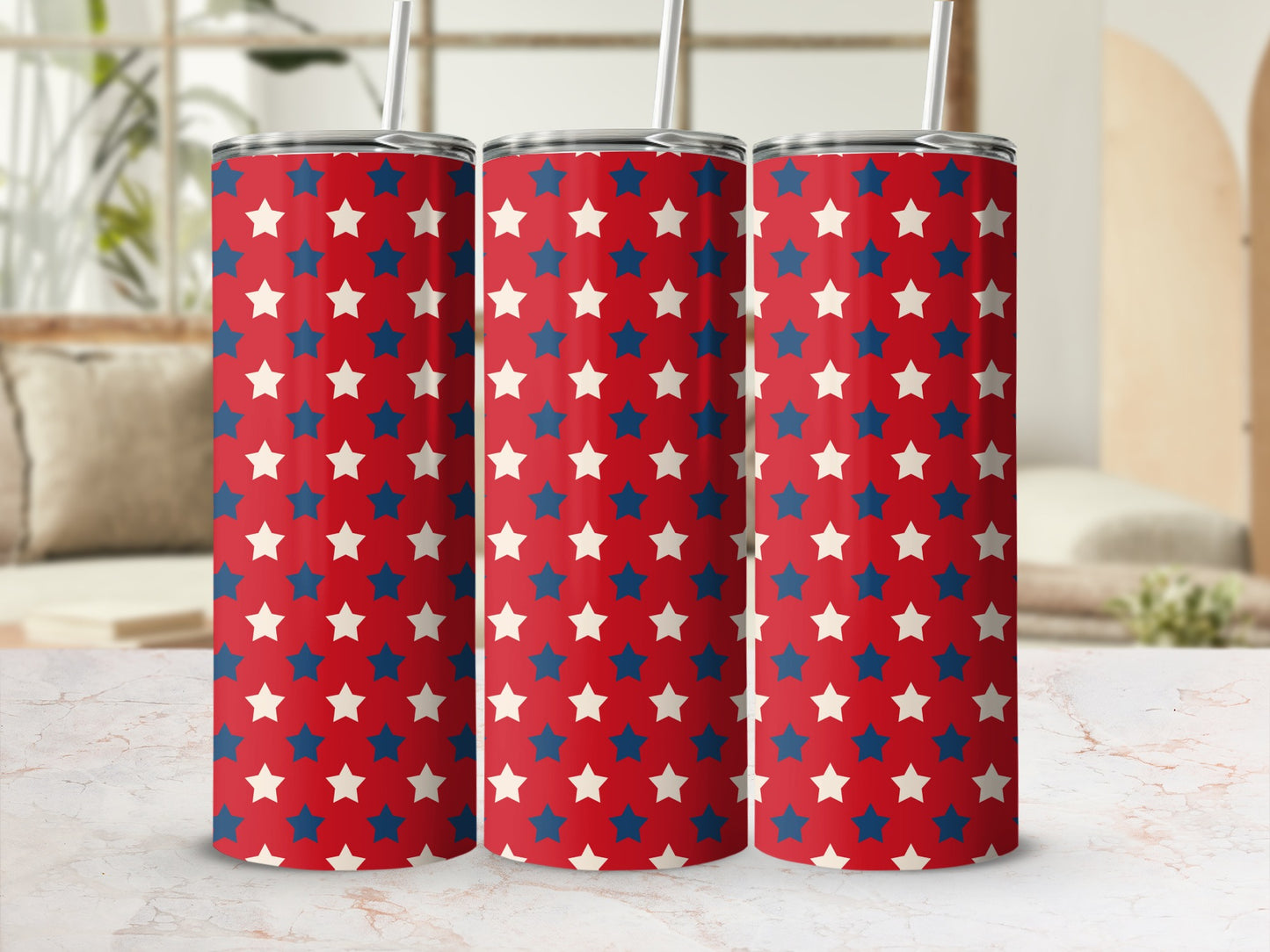 Three tumblers with red, white, and blue stars pattern and reusable straws.