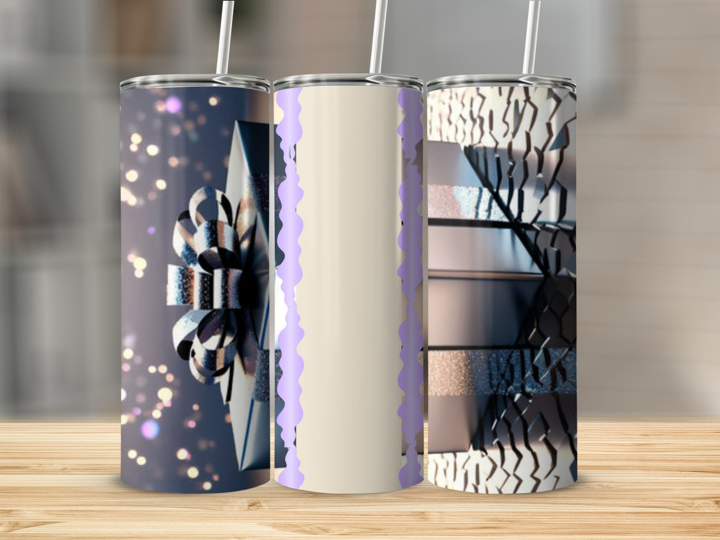 Three tapered tumblers with decorative designs and straws.