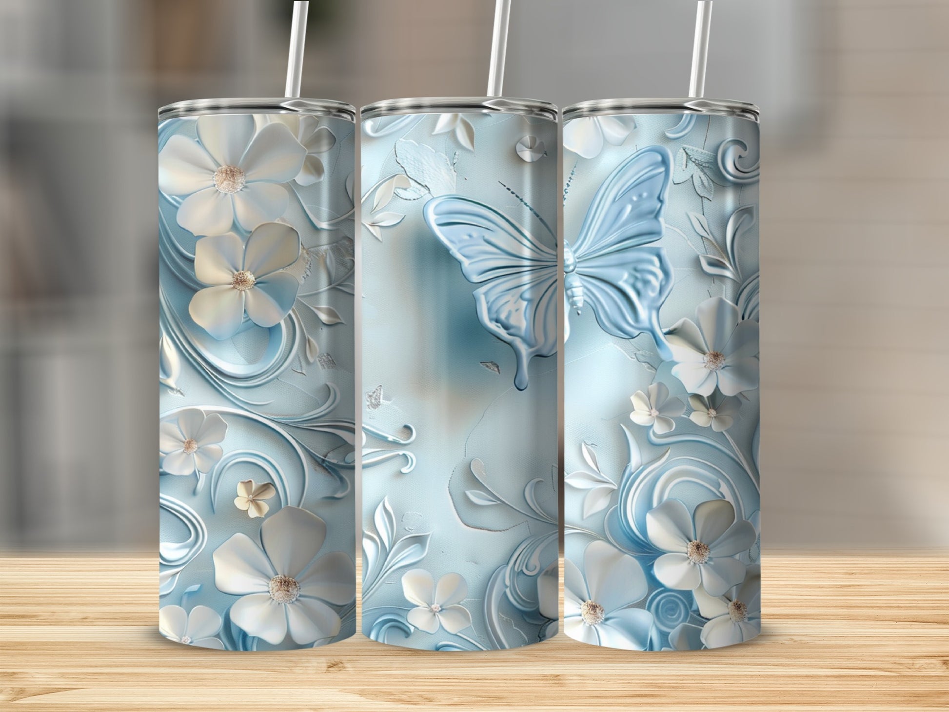 Blue tumbler with butterfly and floral embossed design.