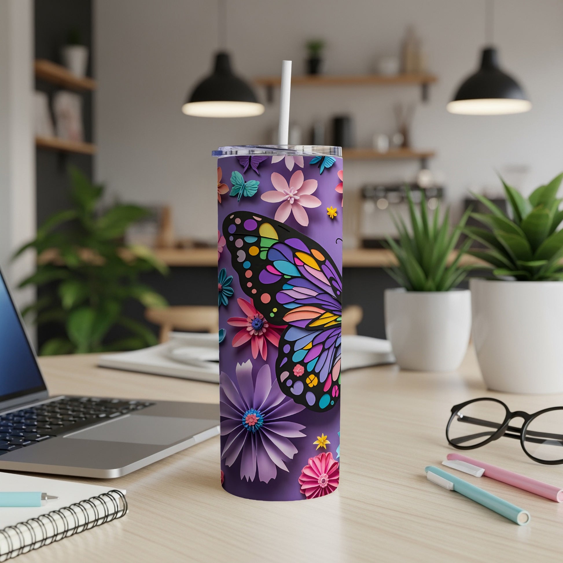 Purple tumbler with colorful butterfly and floral designs, straw in lid.