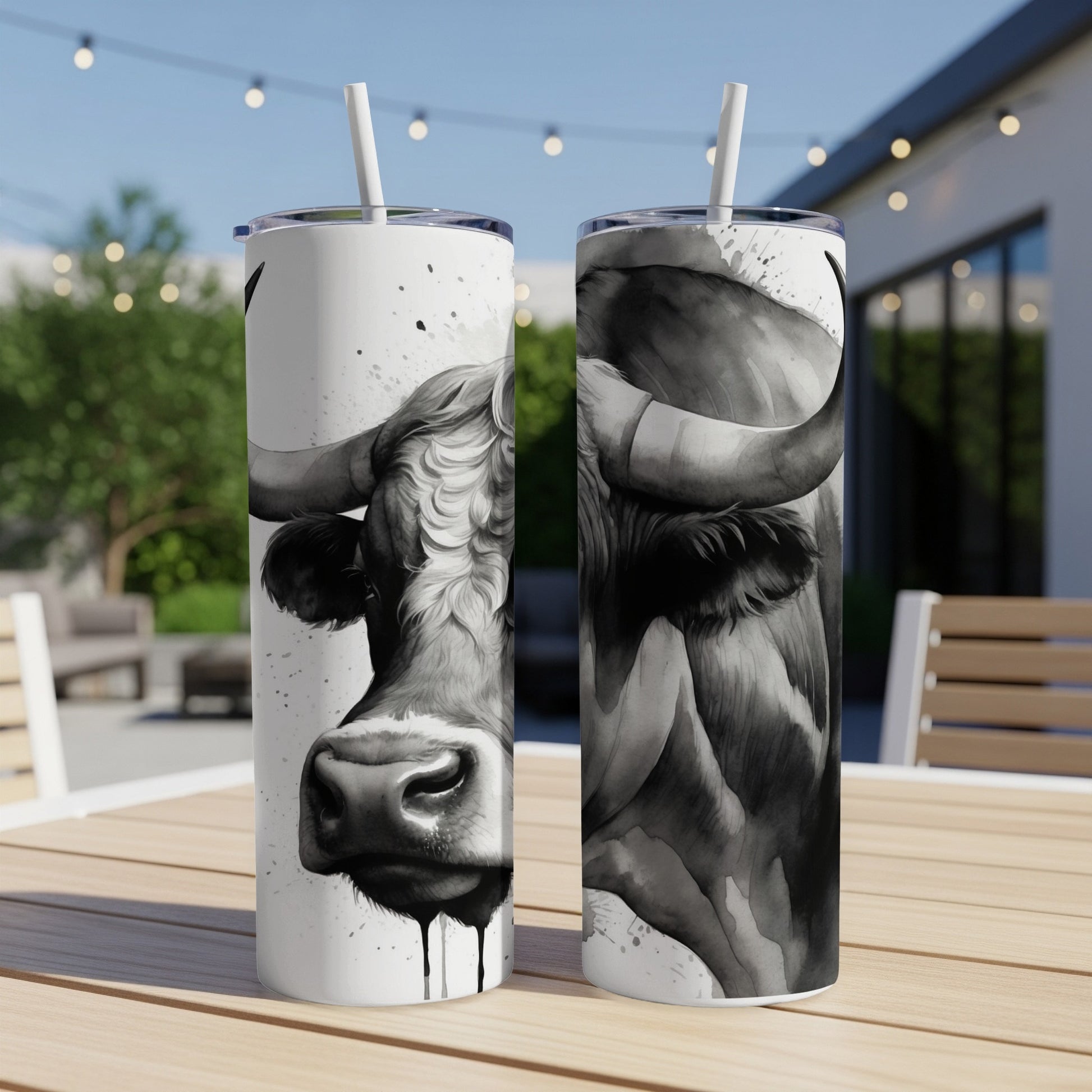 Black and white watercolor bull artwork on two tumblers.