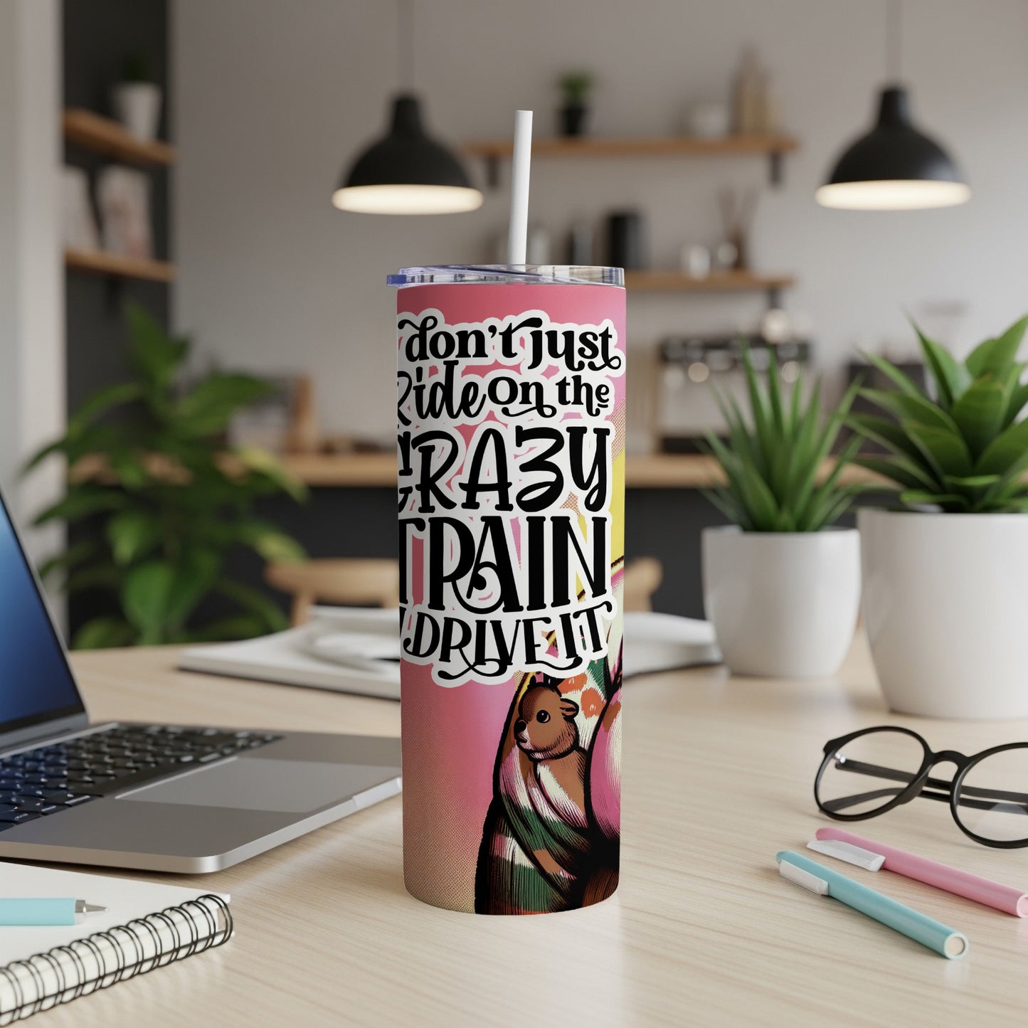 Pink tumbler with "Don't Just Ride the Crazy Train" text and artwork.