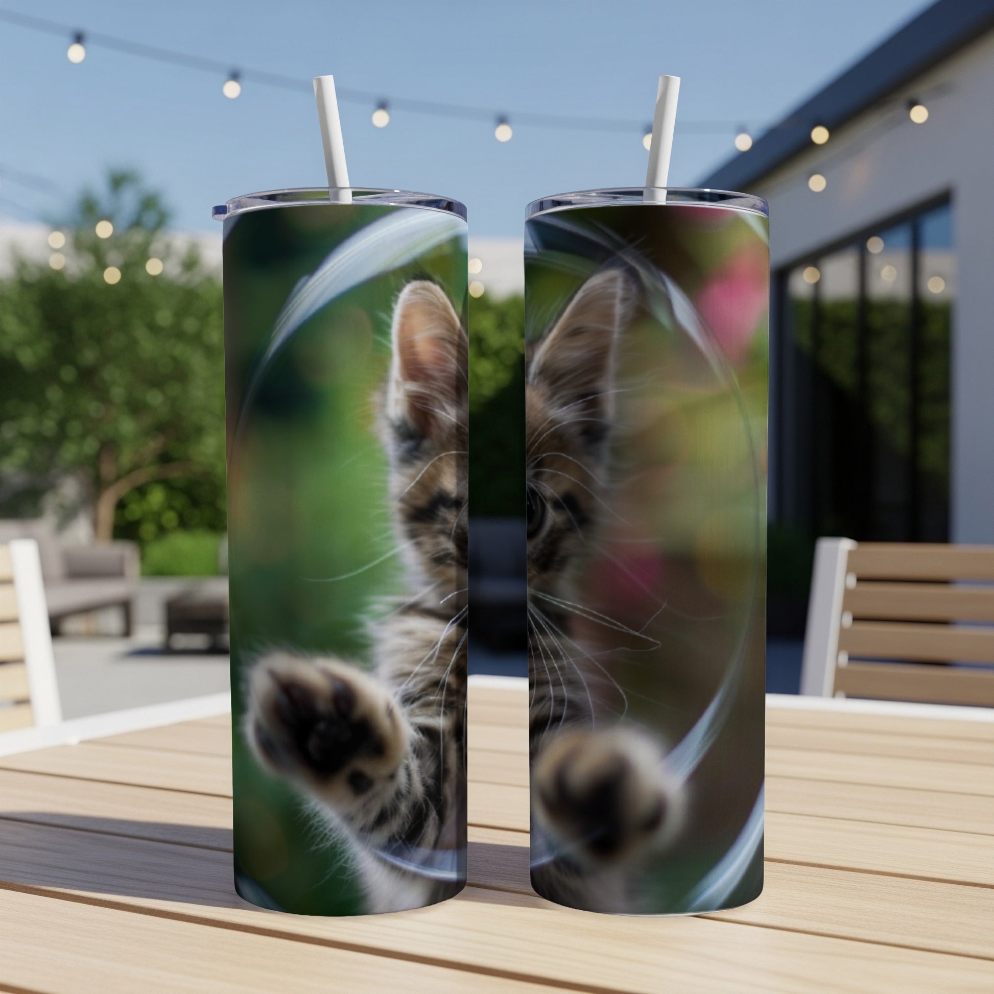 Kitten pawing at the camera on a blurred background, on a tumbler.