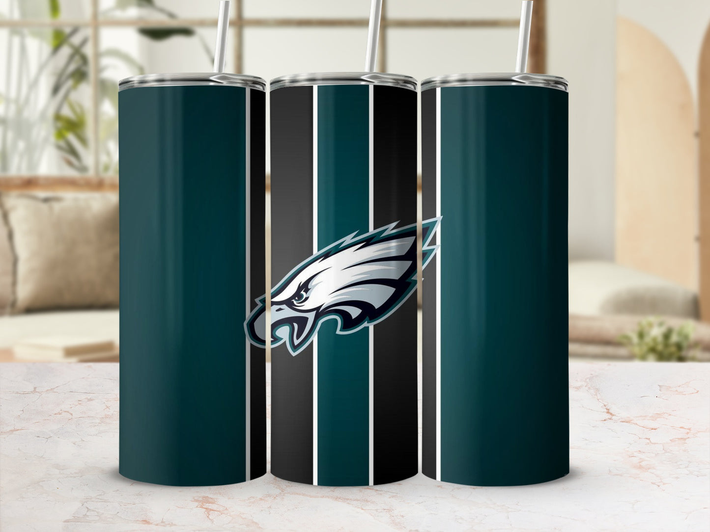 Philadelphia Eagles logo on a striped tumbler with a straw.