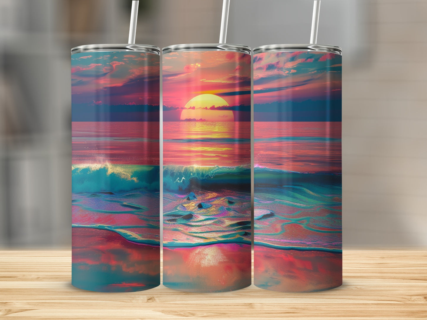 Three tumblers with a sunset ocean wave design.