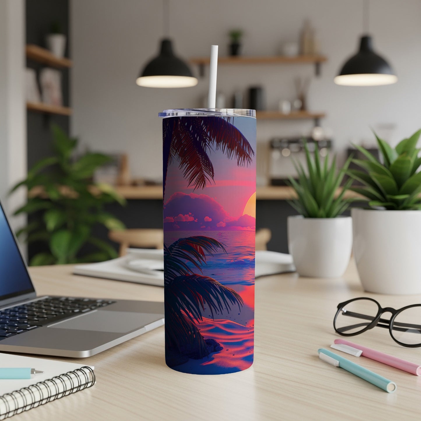 Tropical sunset beach scene on a blue tumbler with a straw.