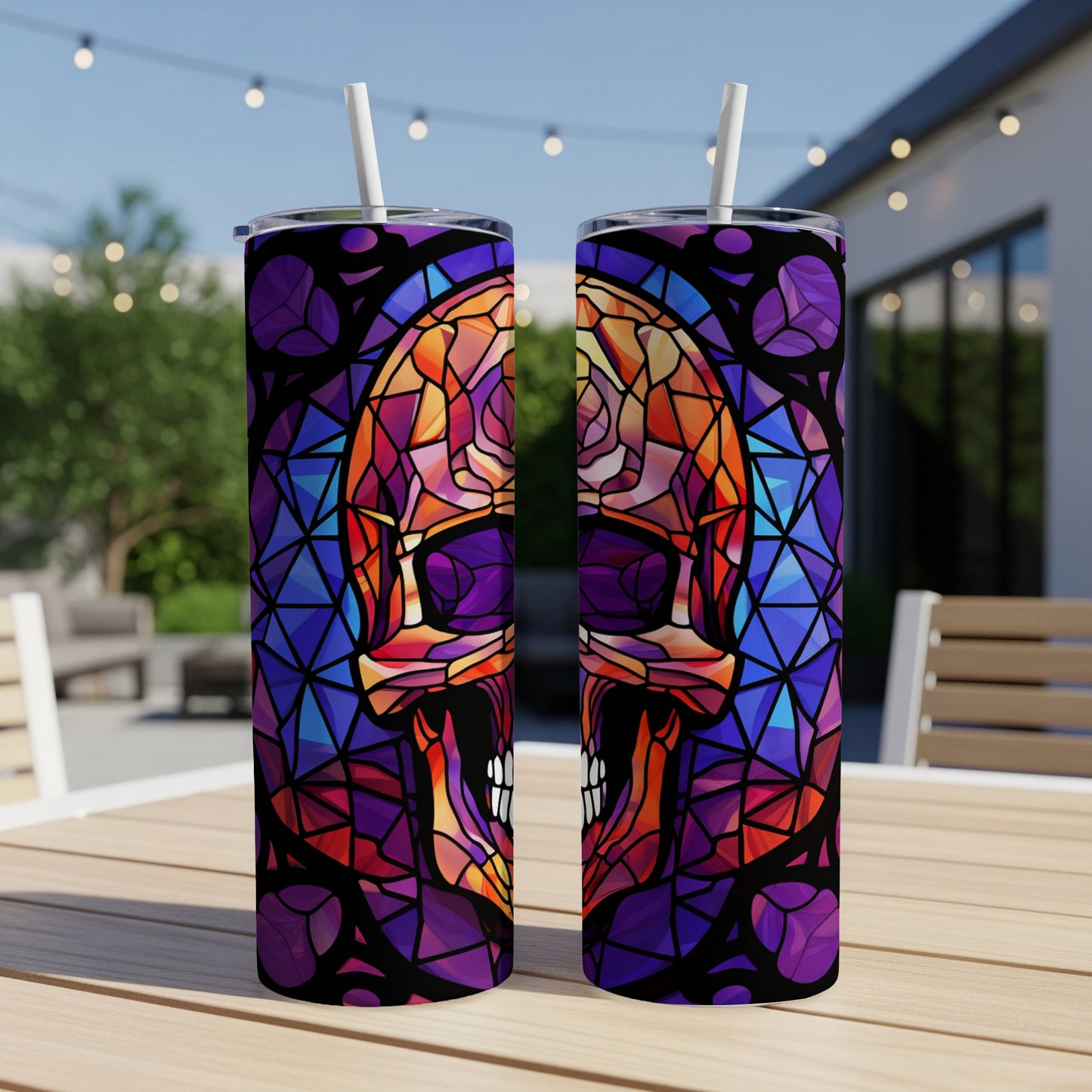 Two tumblers with a stained-glass skull design on a table.