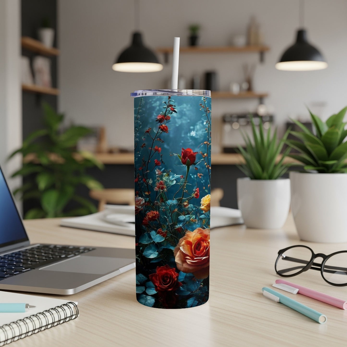 Tall tumbler with red and orange roses against a dark blue floral background.