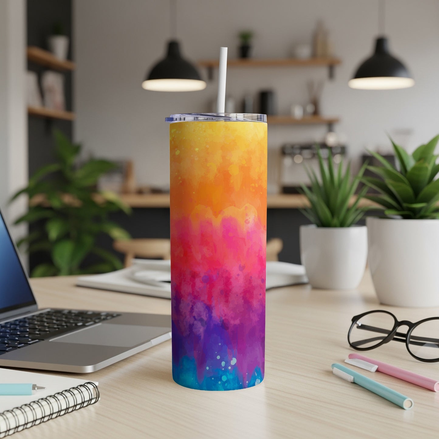 Tall tumbler with a vibrant watercolor design, featuring yellow, orange, pink, and blue.