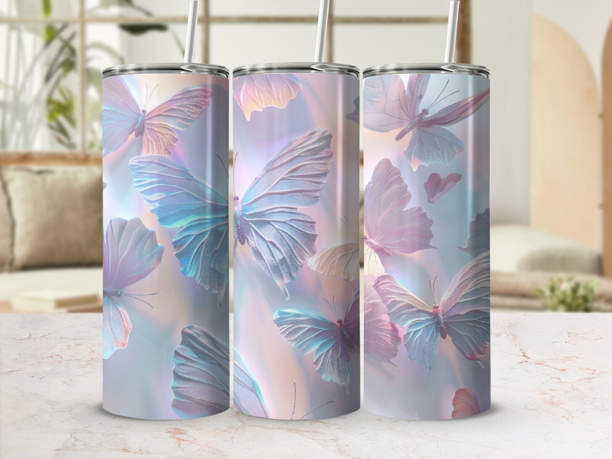 Three iridescent tumblers with butterfly patterns on a marble surface.