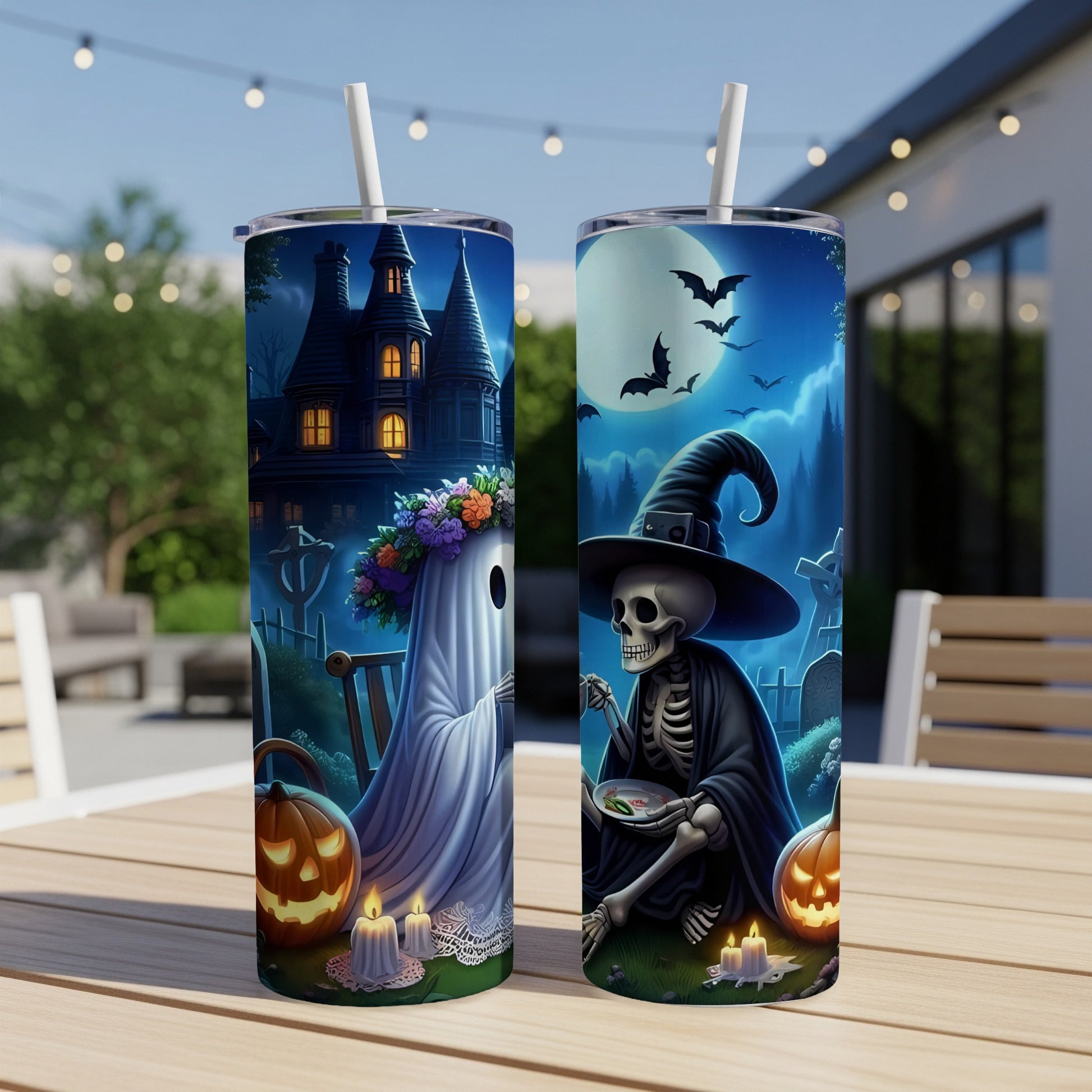 Two tumblers with Halloween art: haunted house and ghost, skeleton with hat, bats, moon, pumpkins, and candles.