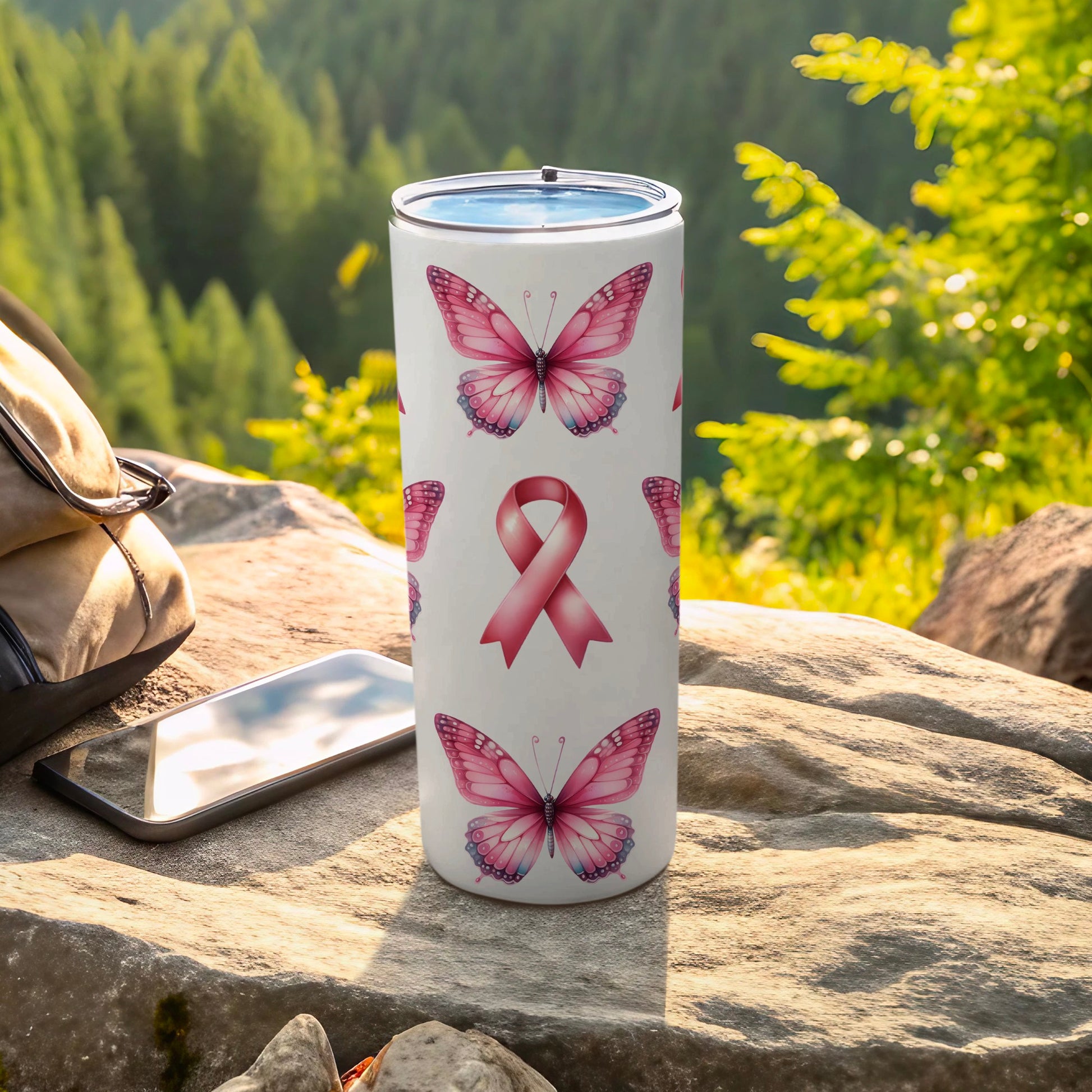 Tumbler with pink butterflies and a repeating awareness ribbon pattern.