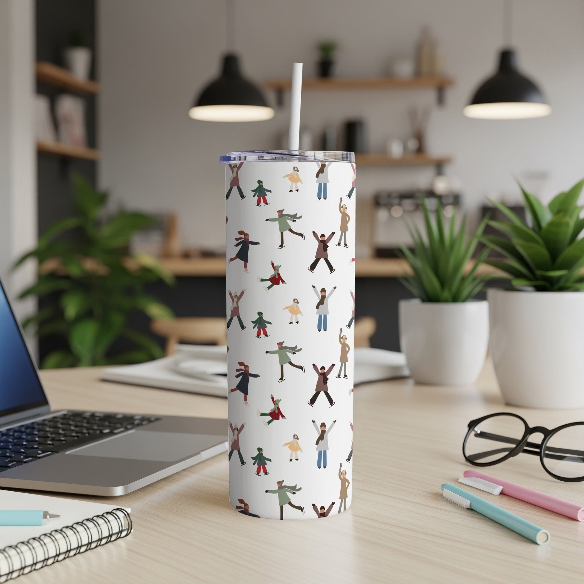 White tumbler with a repeating pattern of ice skaters.