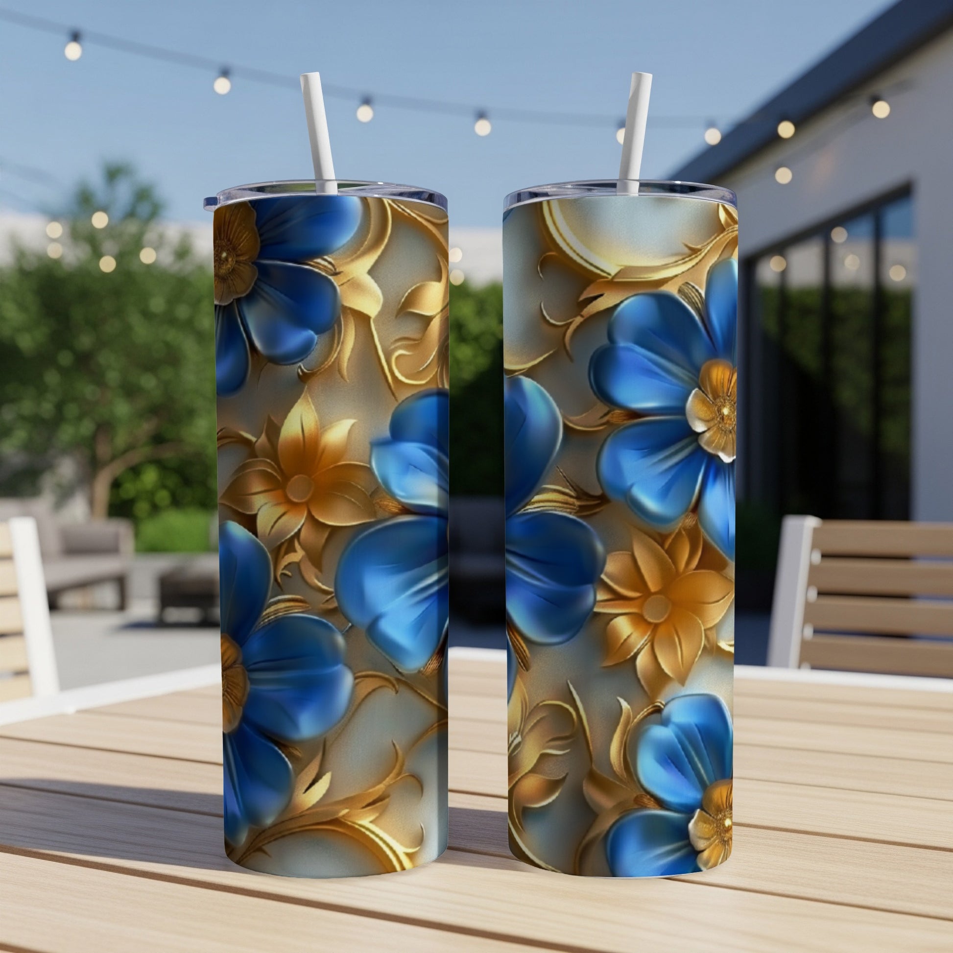Two tumblers with blue and gold floral design on a table.