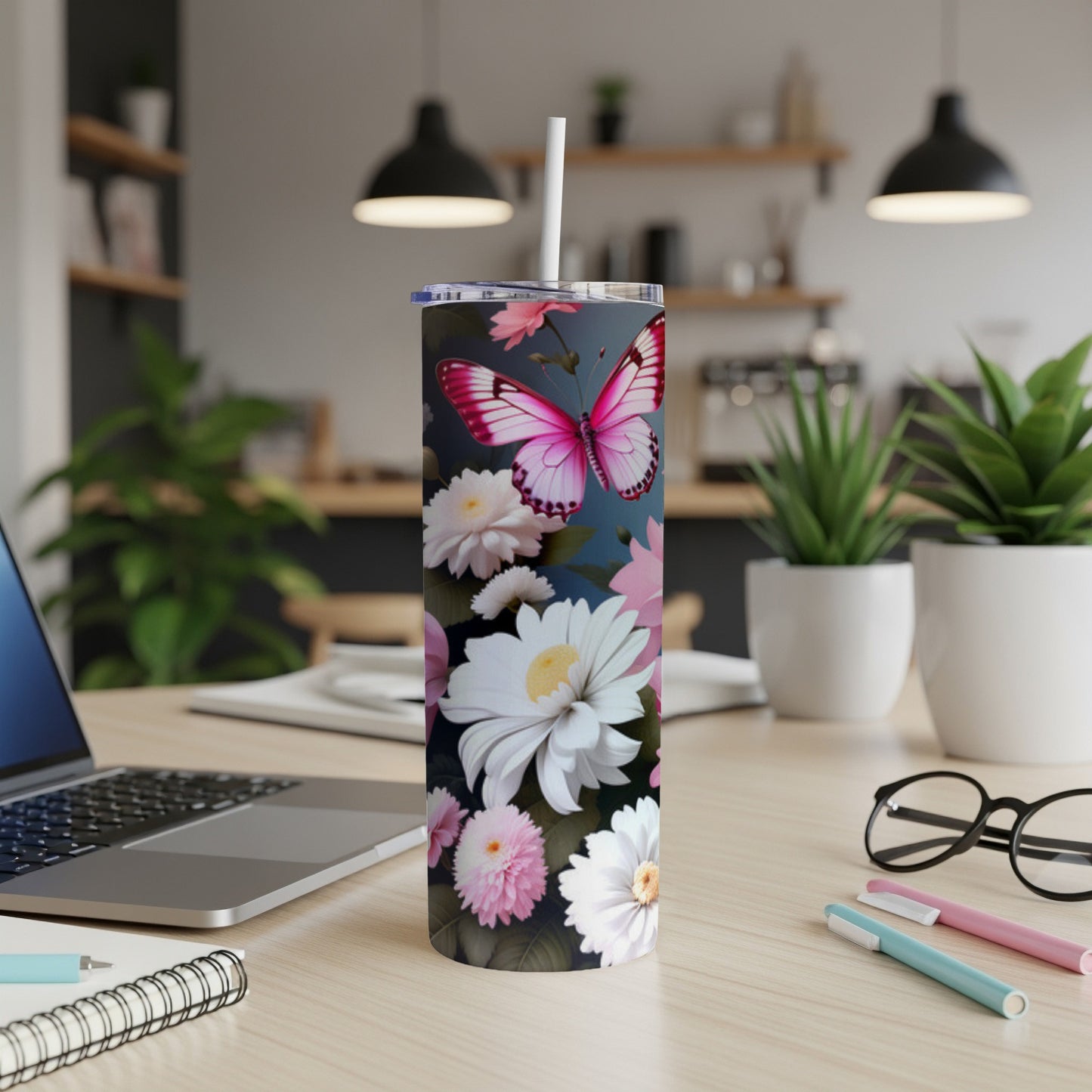 Pink butterfly and floral design on a white skinny tumbler.