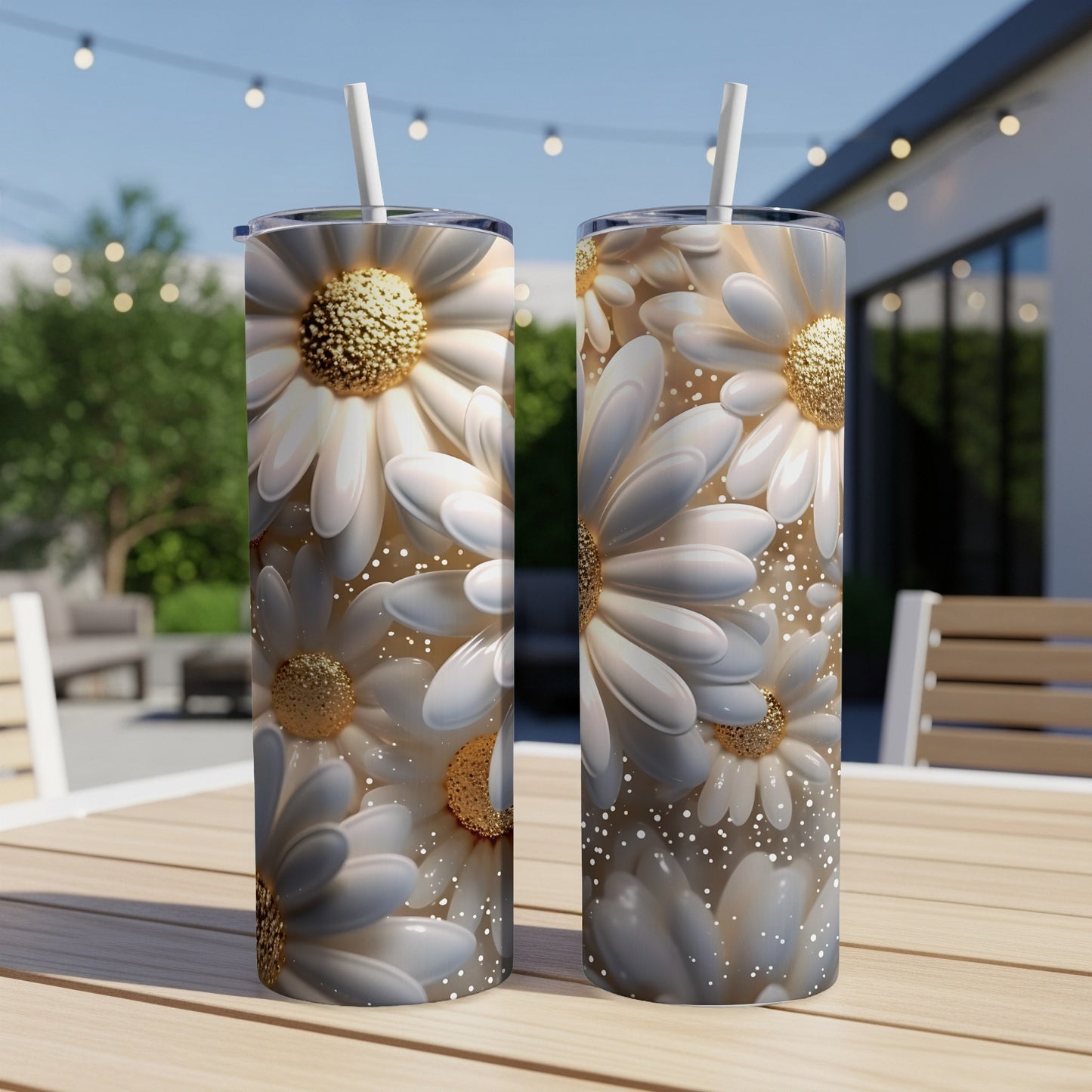 Two tall tumblers with white daisy floral design, straws inserted.