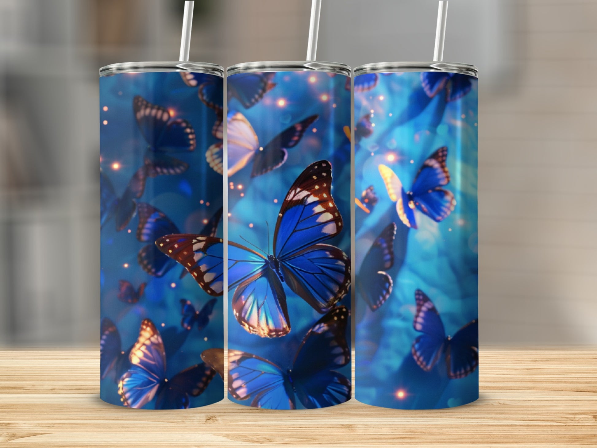 Three tumblers with blue butterflies and bokeh lights.