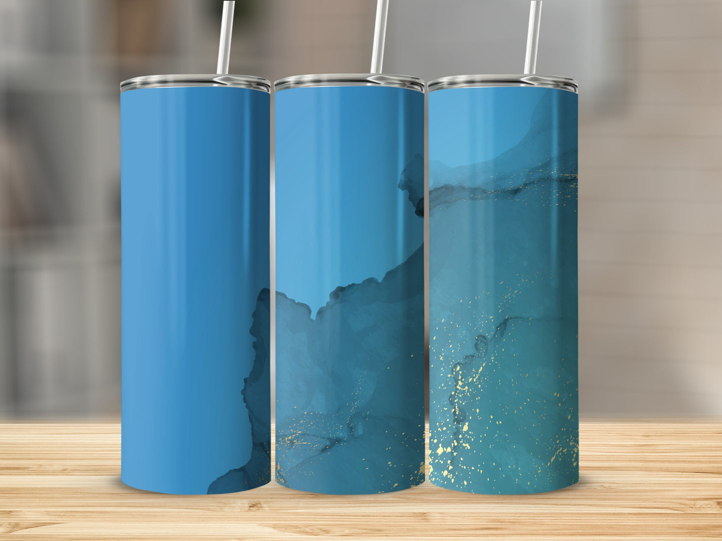 Three tumblers with blue and gold marble design on a wooden surface.