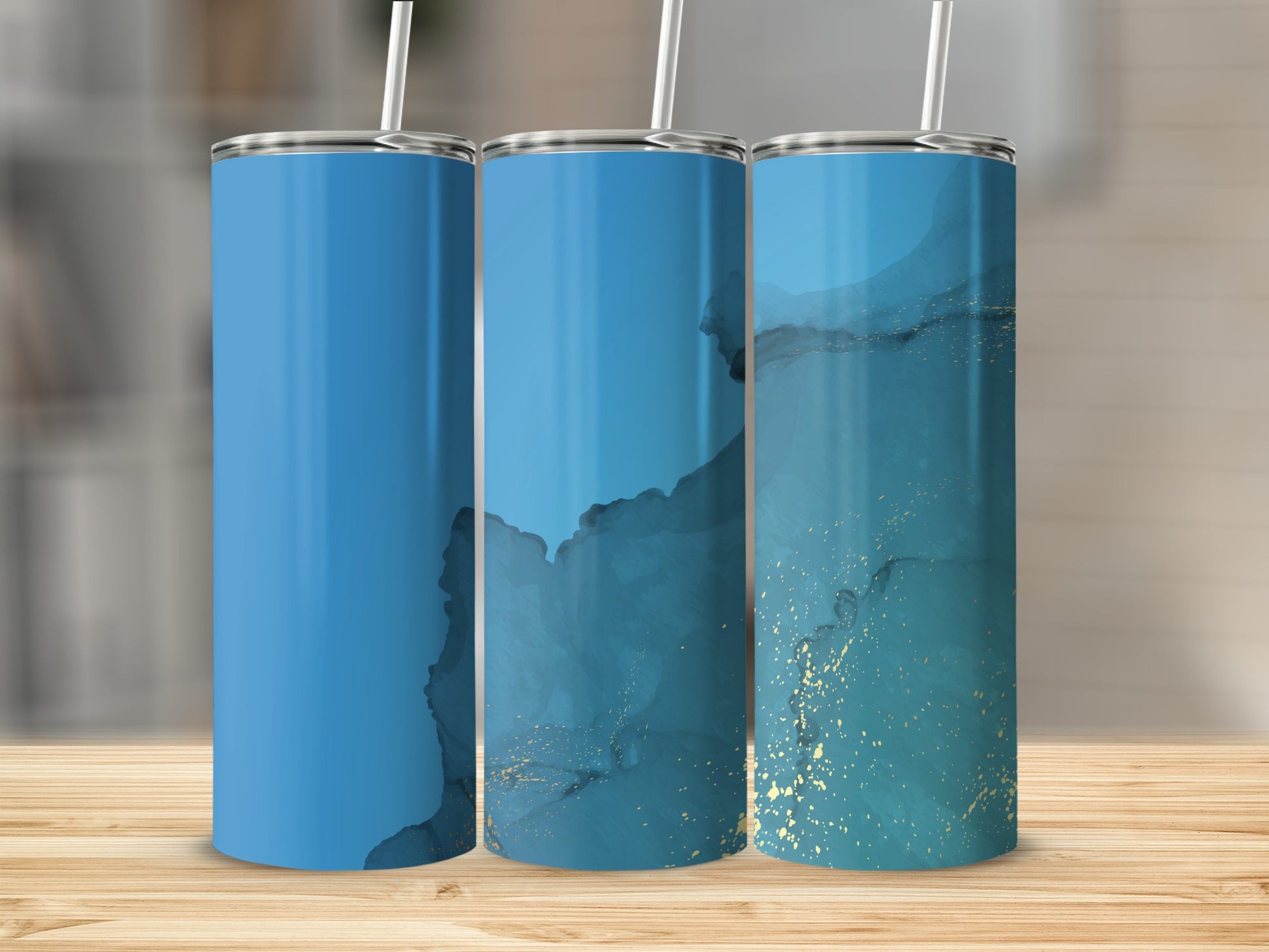 Three tumblers with blue and gold marble design on a wooden surface.
