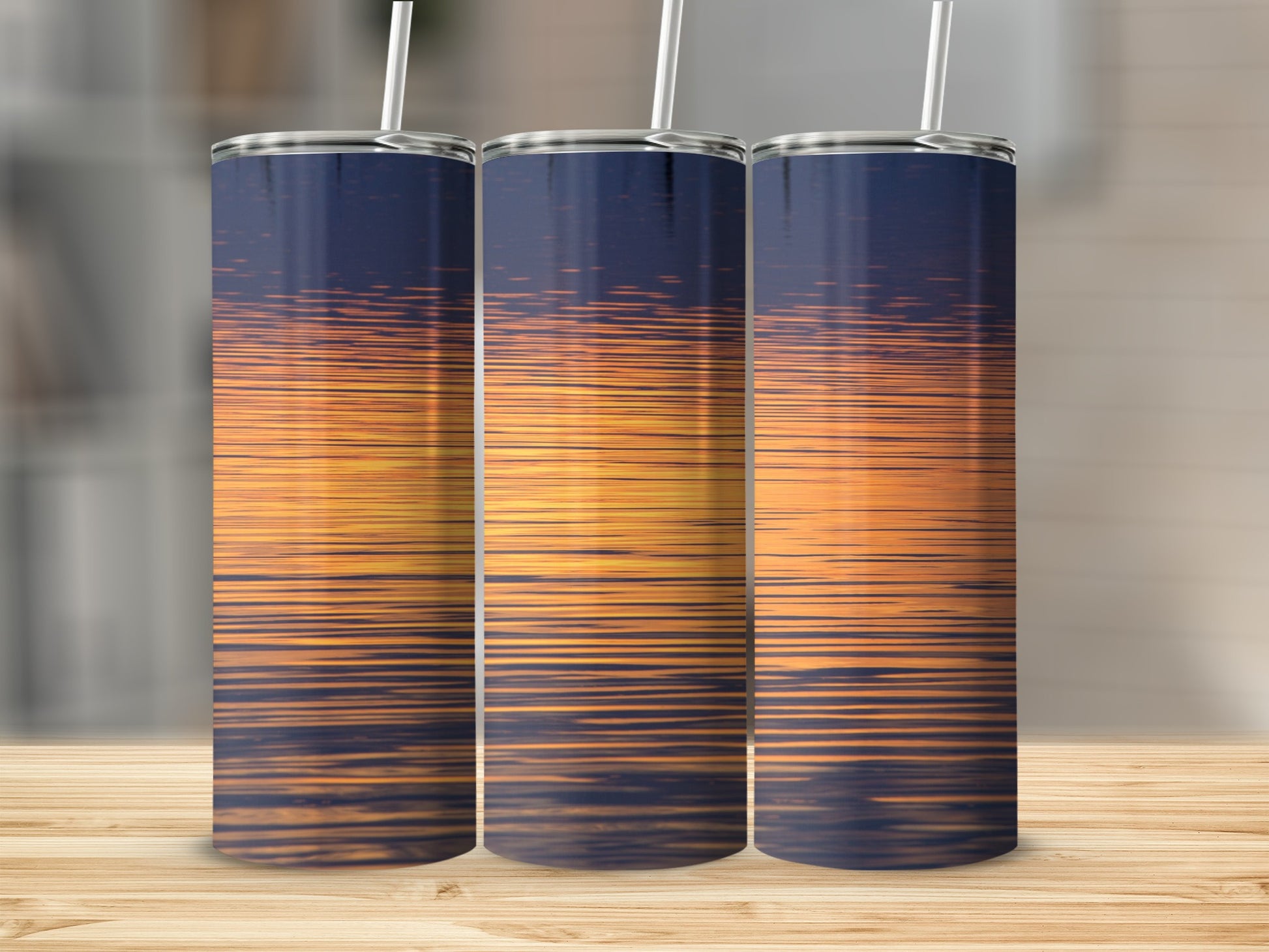 Three tumblers with a sunset reflection design.