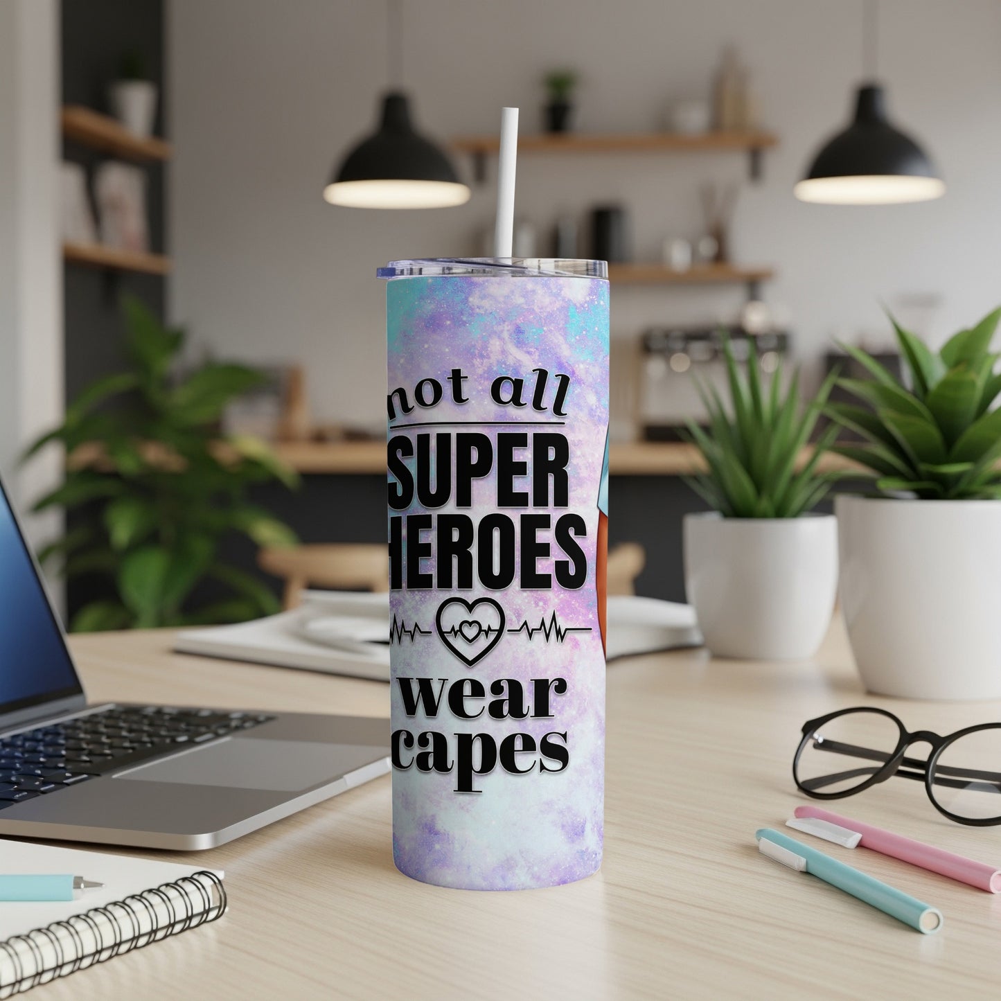 Tall tumbler with "Not all superheroes wear capes" text and colorful galaxy design.