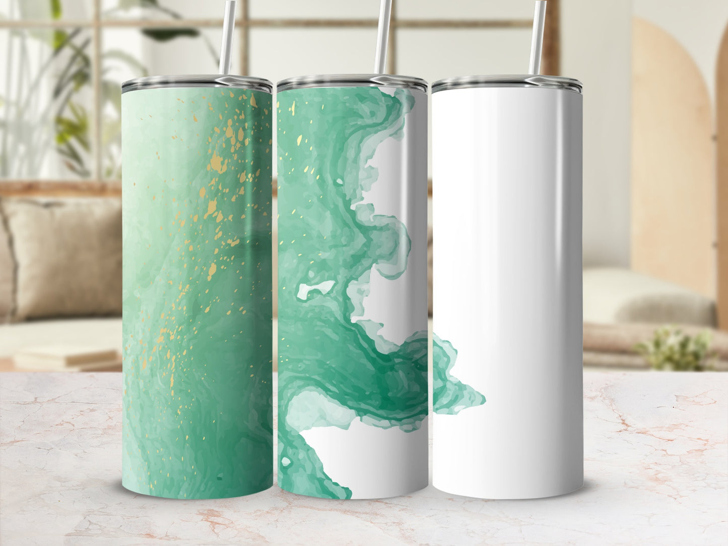 Three tumblers, two with green and gold abstract patterns, one blank.