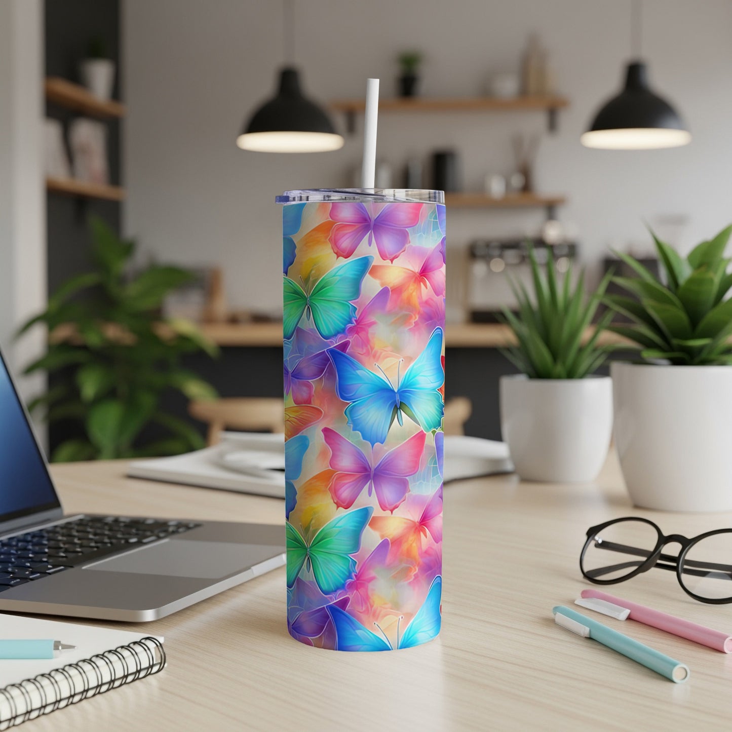 Colorful butterfly pattern on a white tumbler with a straw.
