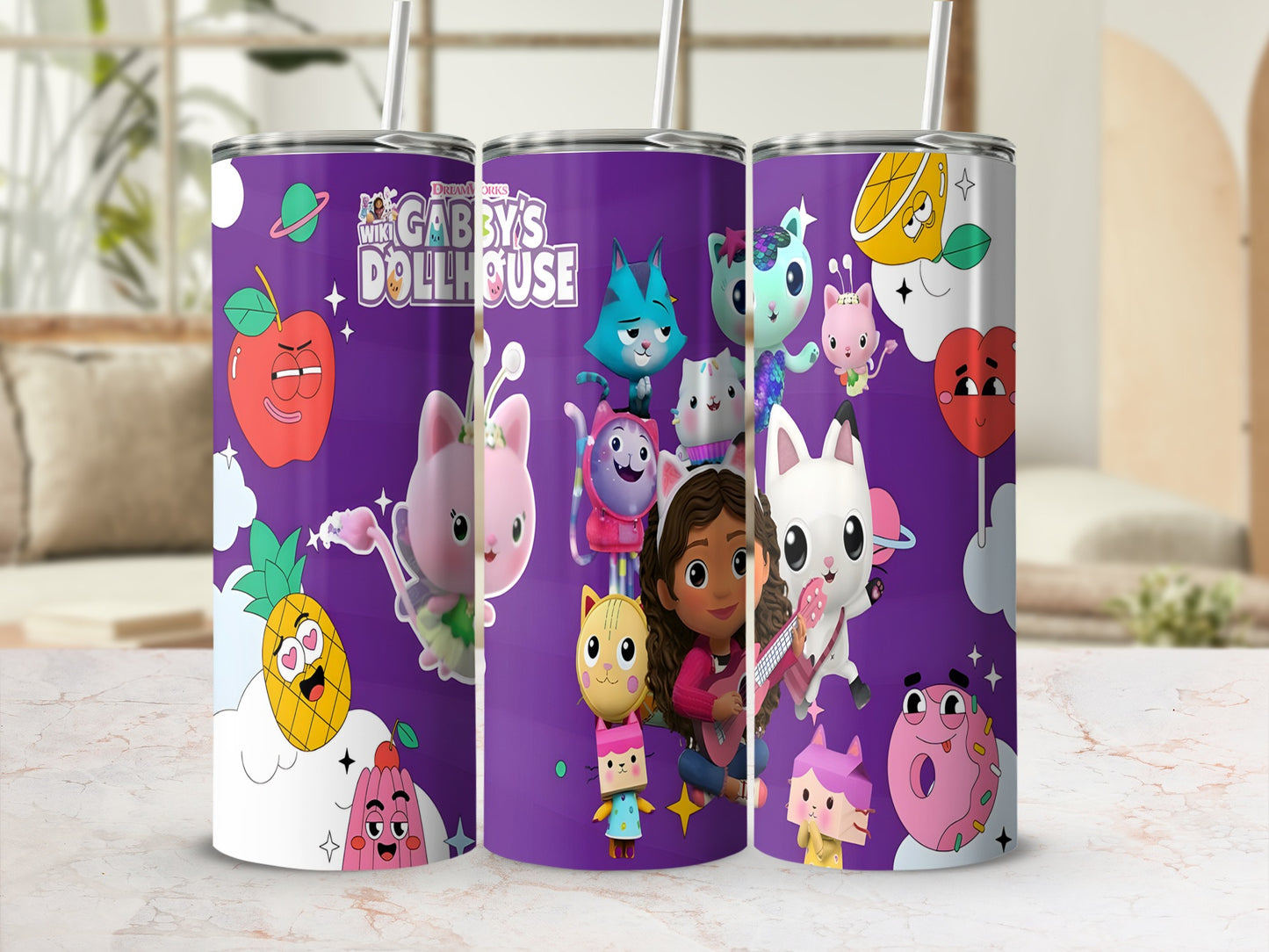 Gabby's Dollhouse characters on a purple tumbler with cartoon fruit and stars.