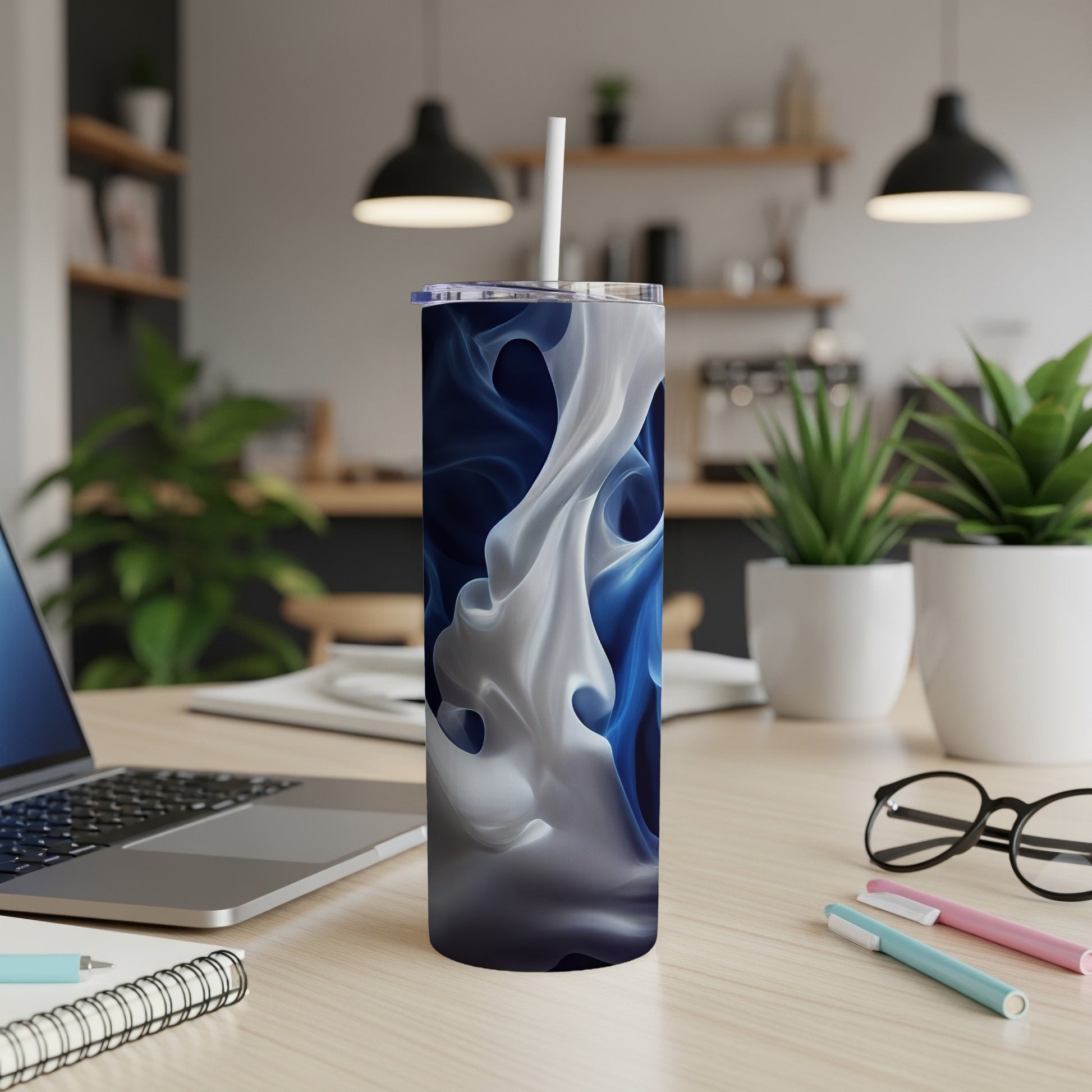 White and blue abstract swirl pattern on a tumbler with a straw.