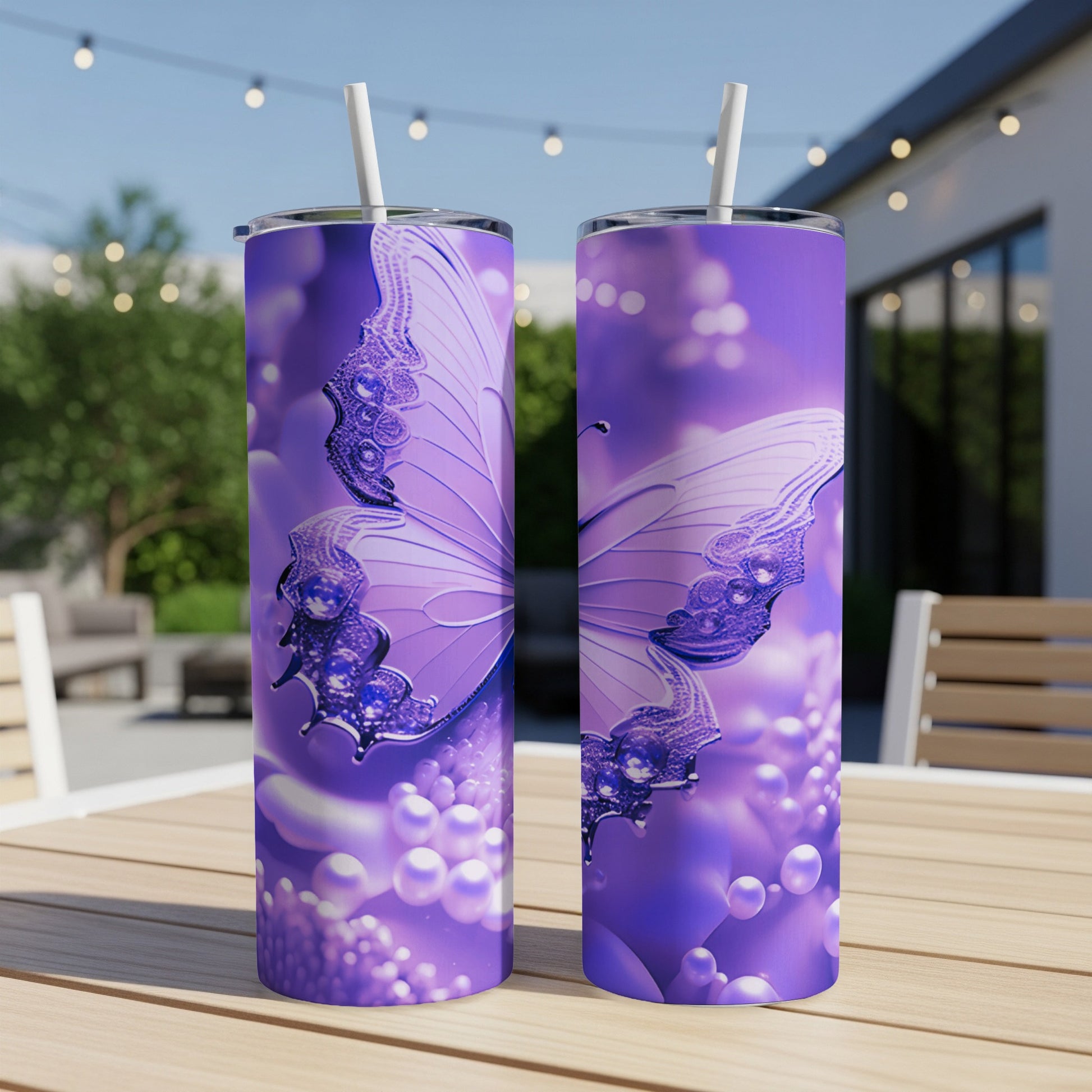 Purple butterfly design on two tumblers with straws.