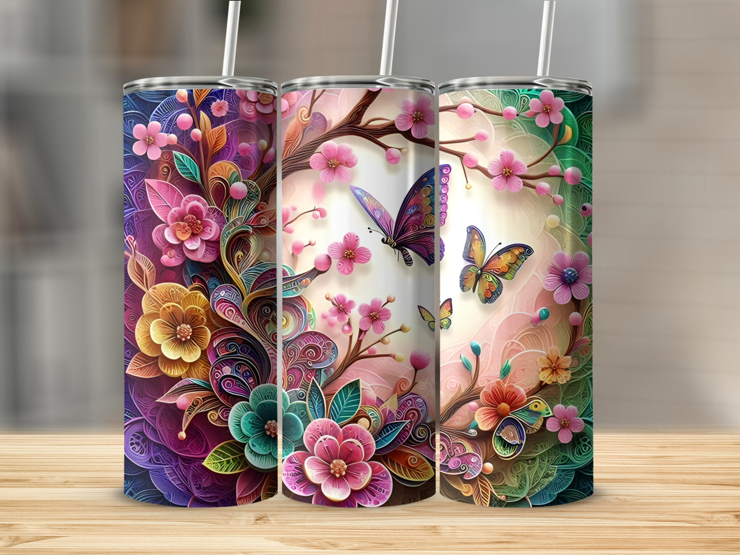 Three tumblers with floral and butterfly designs.