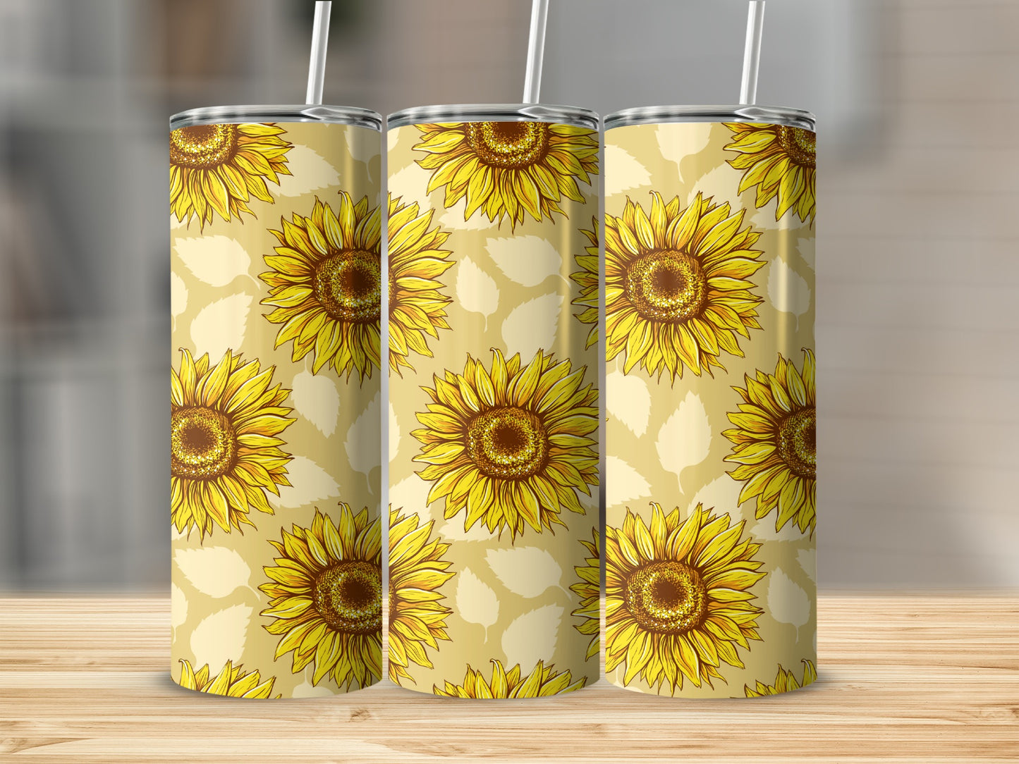 Three tumblers with a repeating sunflower pattern against a light yellow background.