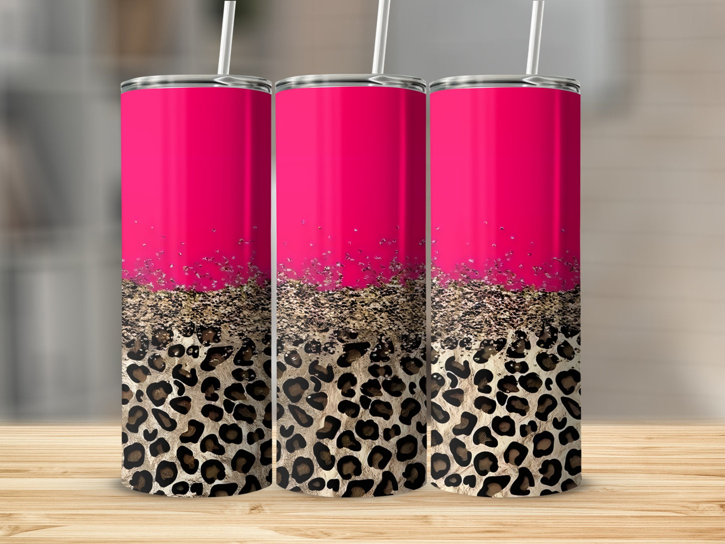 Three tumblers with pink tops and leopard print bases with gold glitter.
