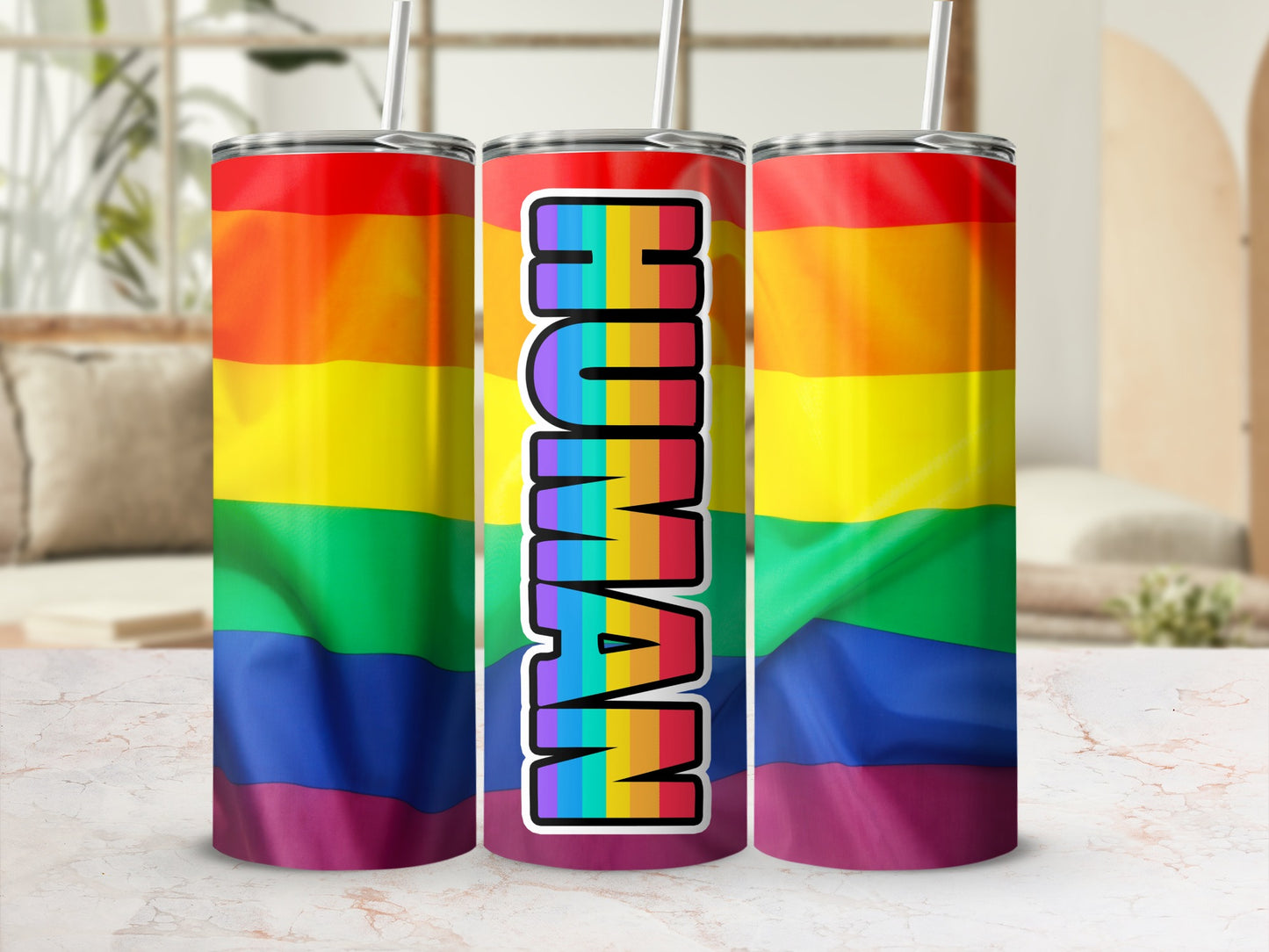 Rainbow gradient tumbler with "HUMAN" text in bold letters.