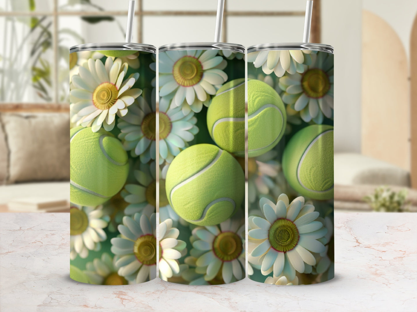 Three tumblers with tennis balls and daisies on a marbled surface.