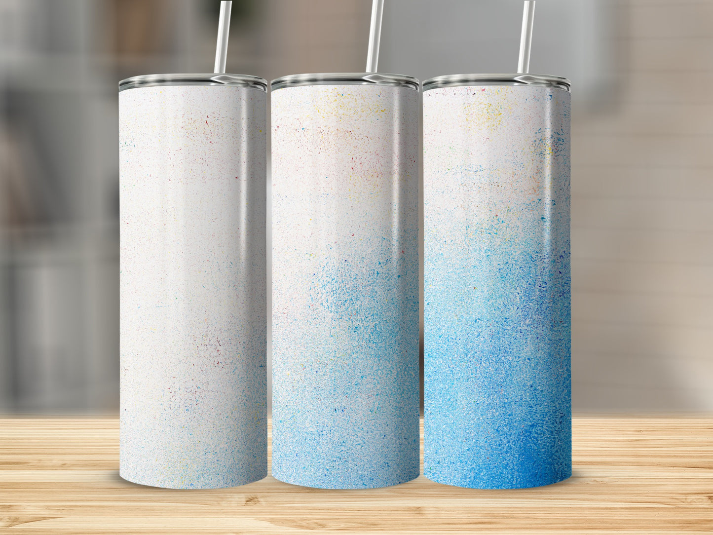 Three sublimation tumblers with colorful speckled gradient designs.