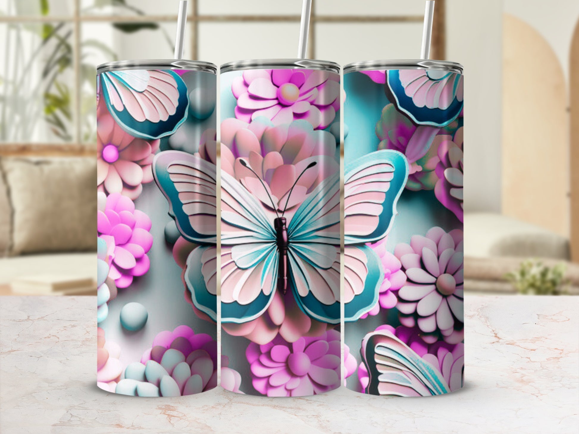 Three tumblers with butterflies and pink flowers, on a marble surface.