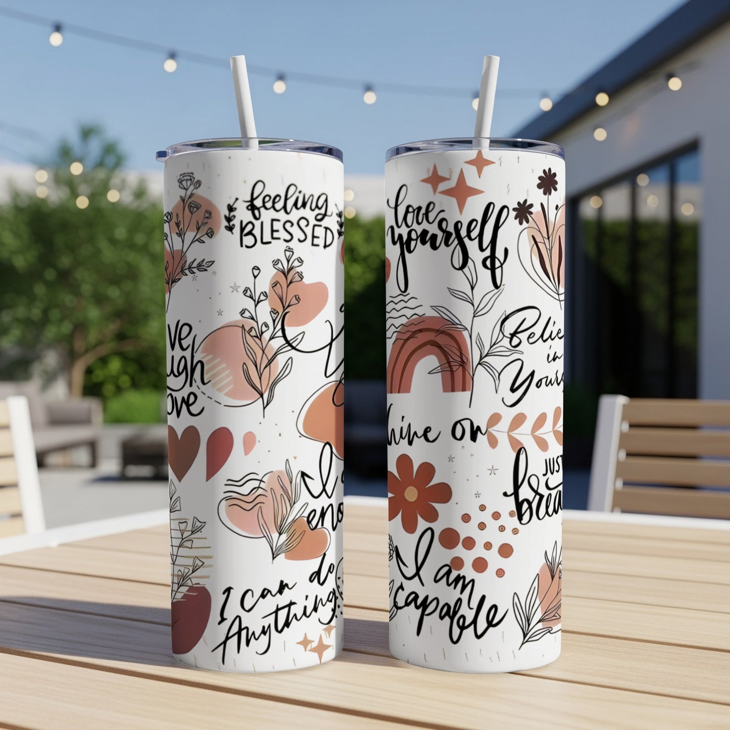 Two tumblers with floral designs and inspirational text.