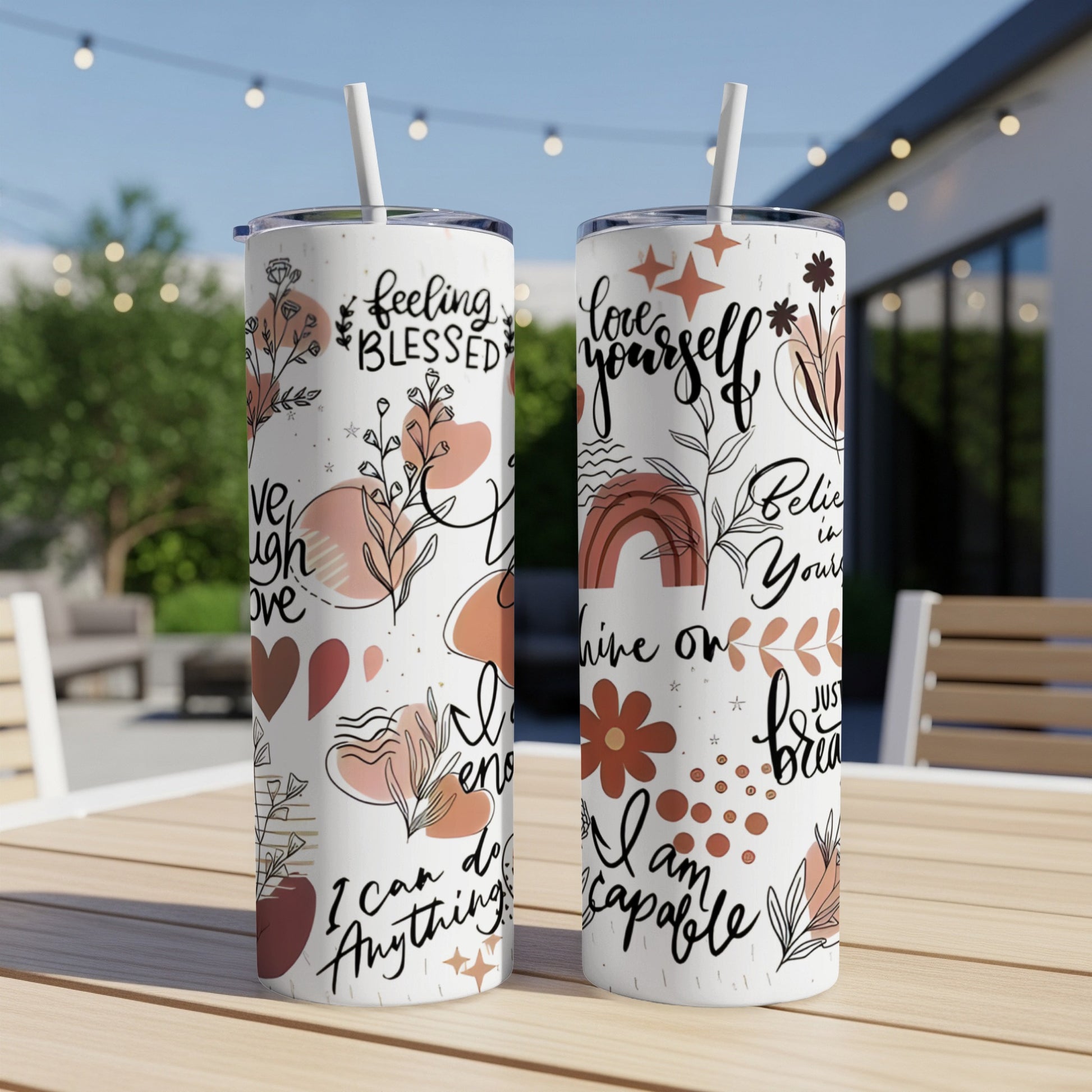 Two tumblers with floral designs and inspirational text.