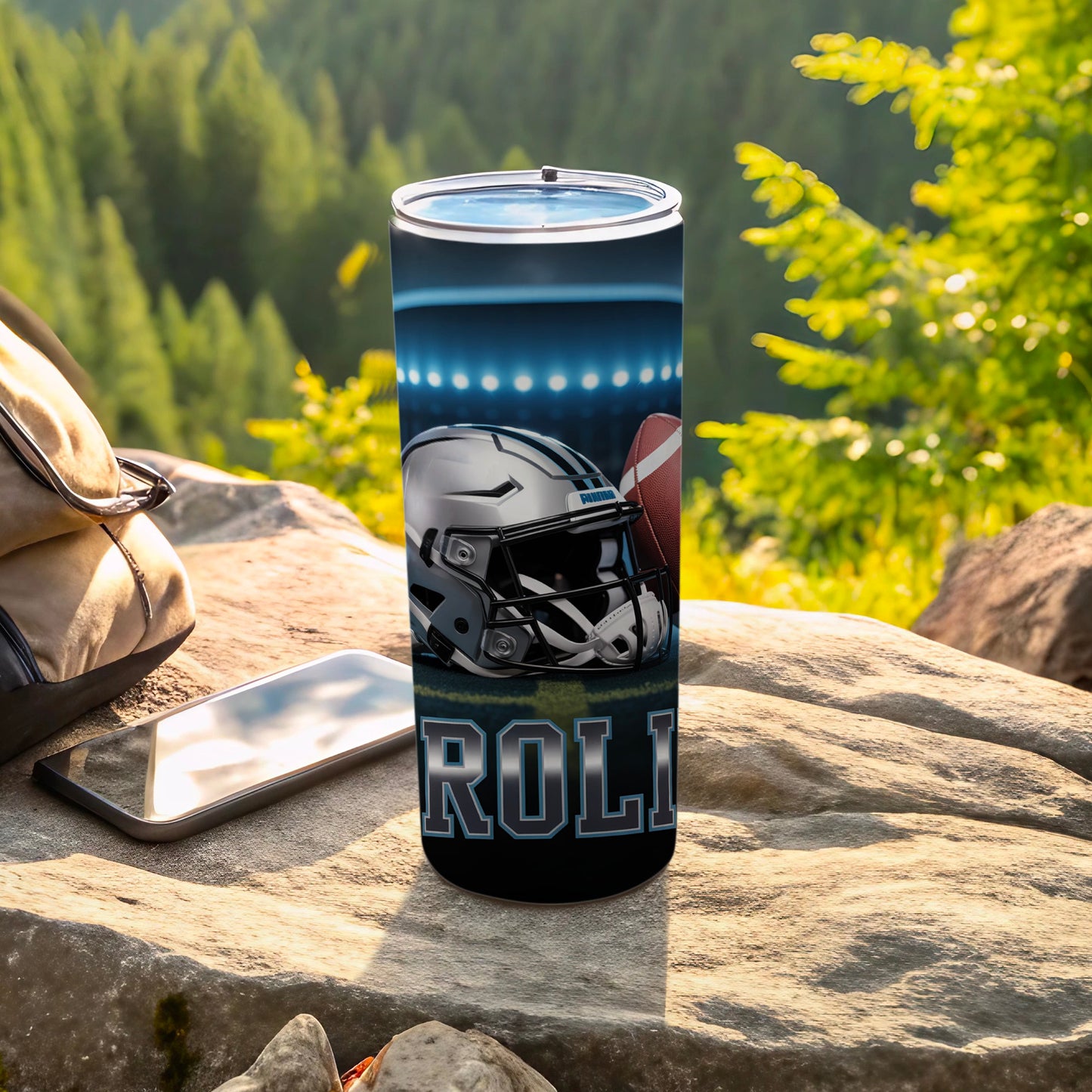 Tumbler with football helmet and ball, Carolina text, outdoor setting.