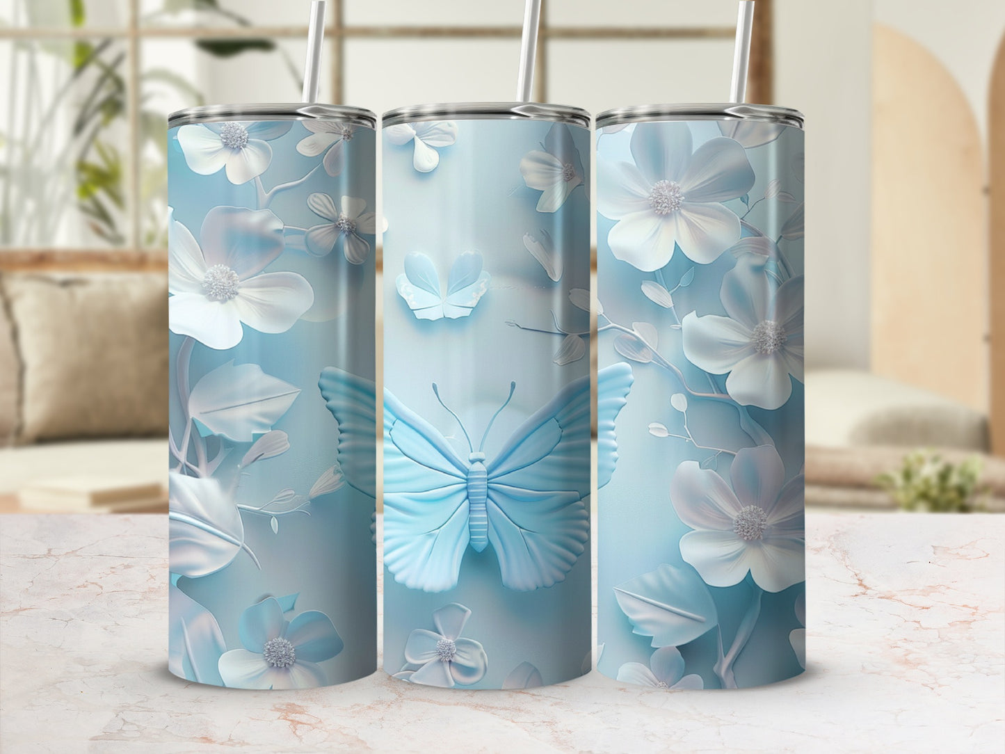 Three light blue tumblers with embossed floral and butterfly designs.