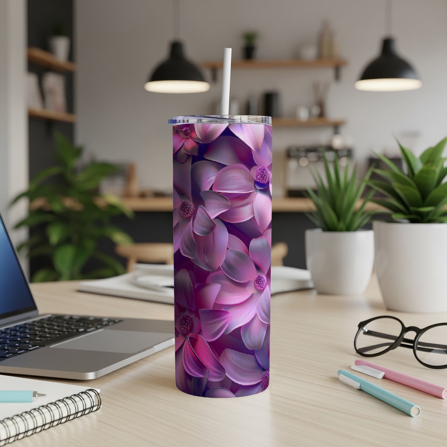 Purple floral pattern on a skinny tumbler with a straw.