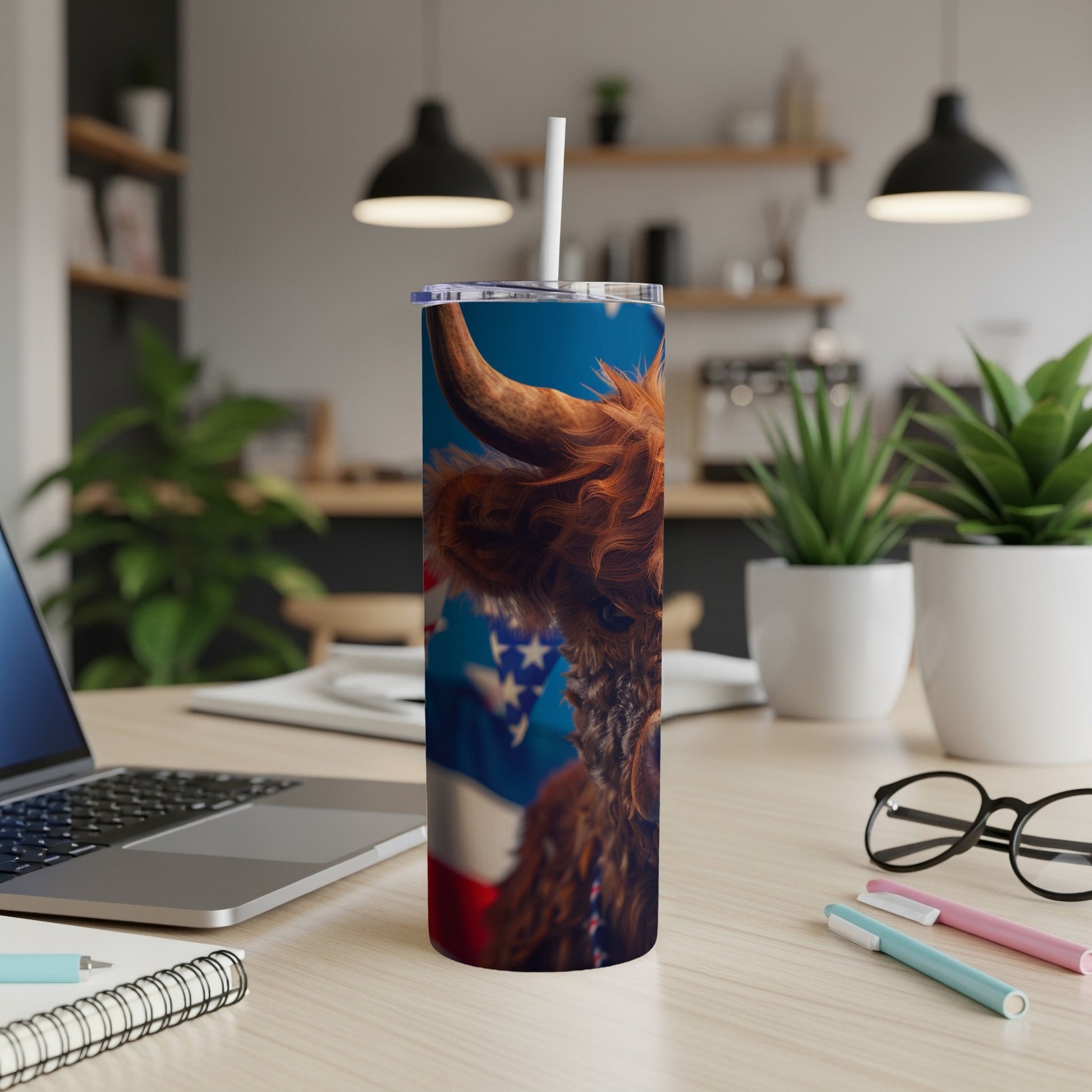Highland cow and American flag design on a stainless steel tumbler.