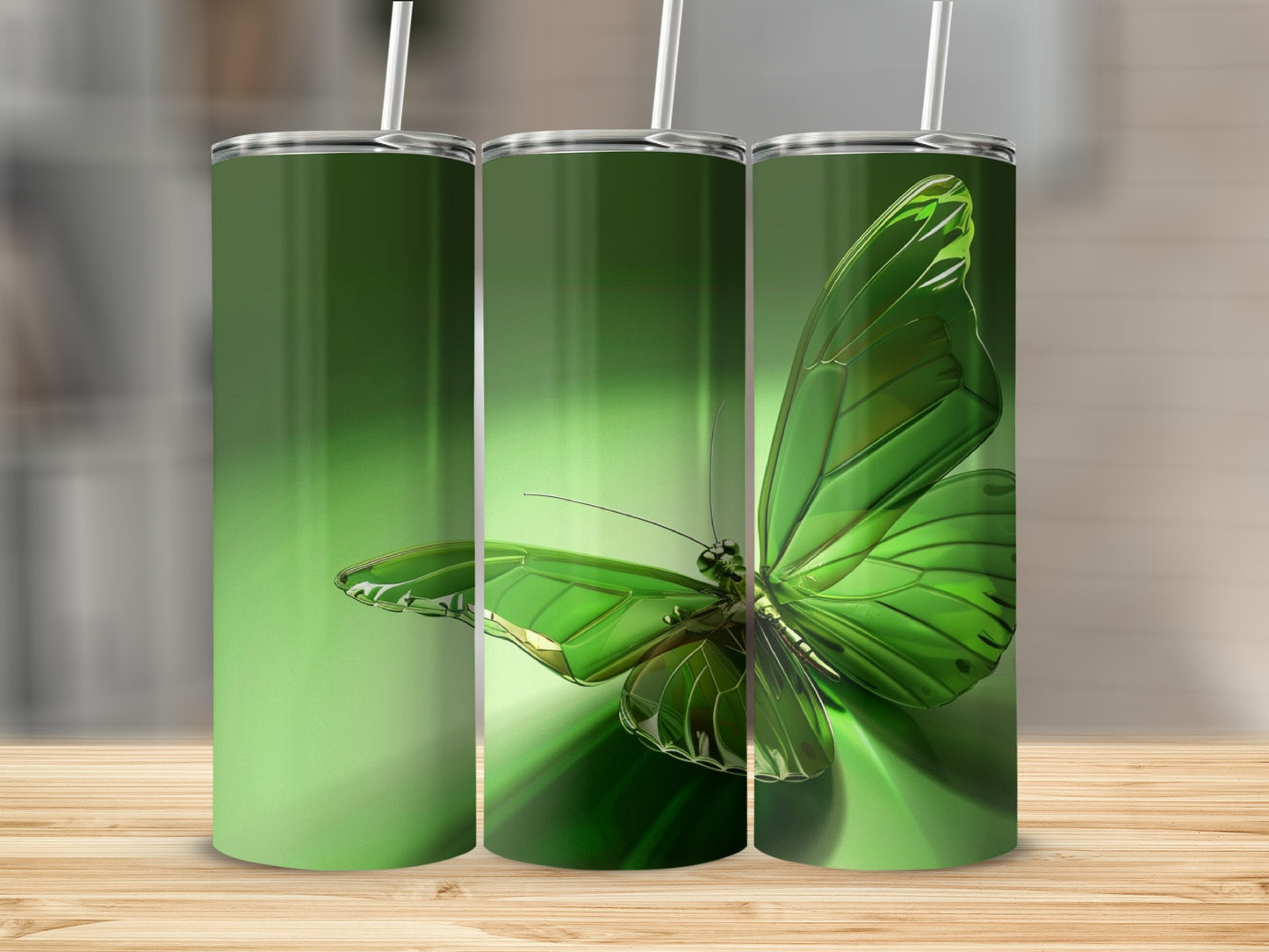 Green butterfly tumbler with straw on wooden surface.