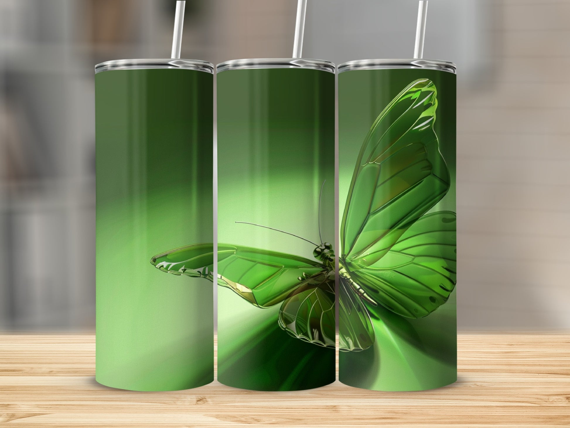 Green butterfly tumbler with straw on wooden surface.